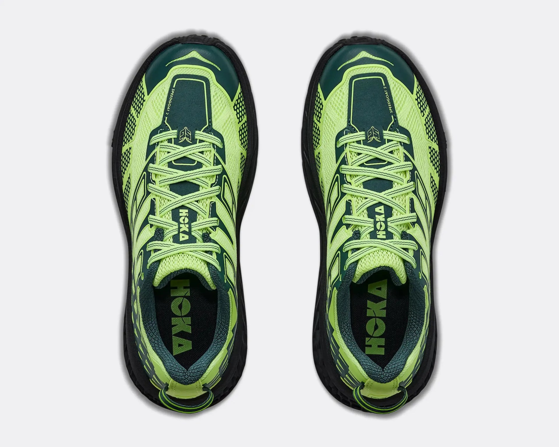 Pair of neon yellow and dark green Hoka Speedgoat 2 running shoes viewed from above.