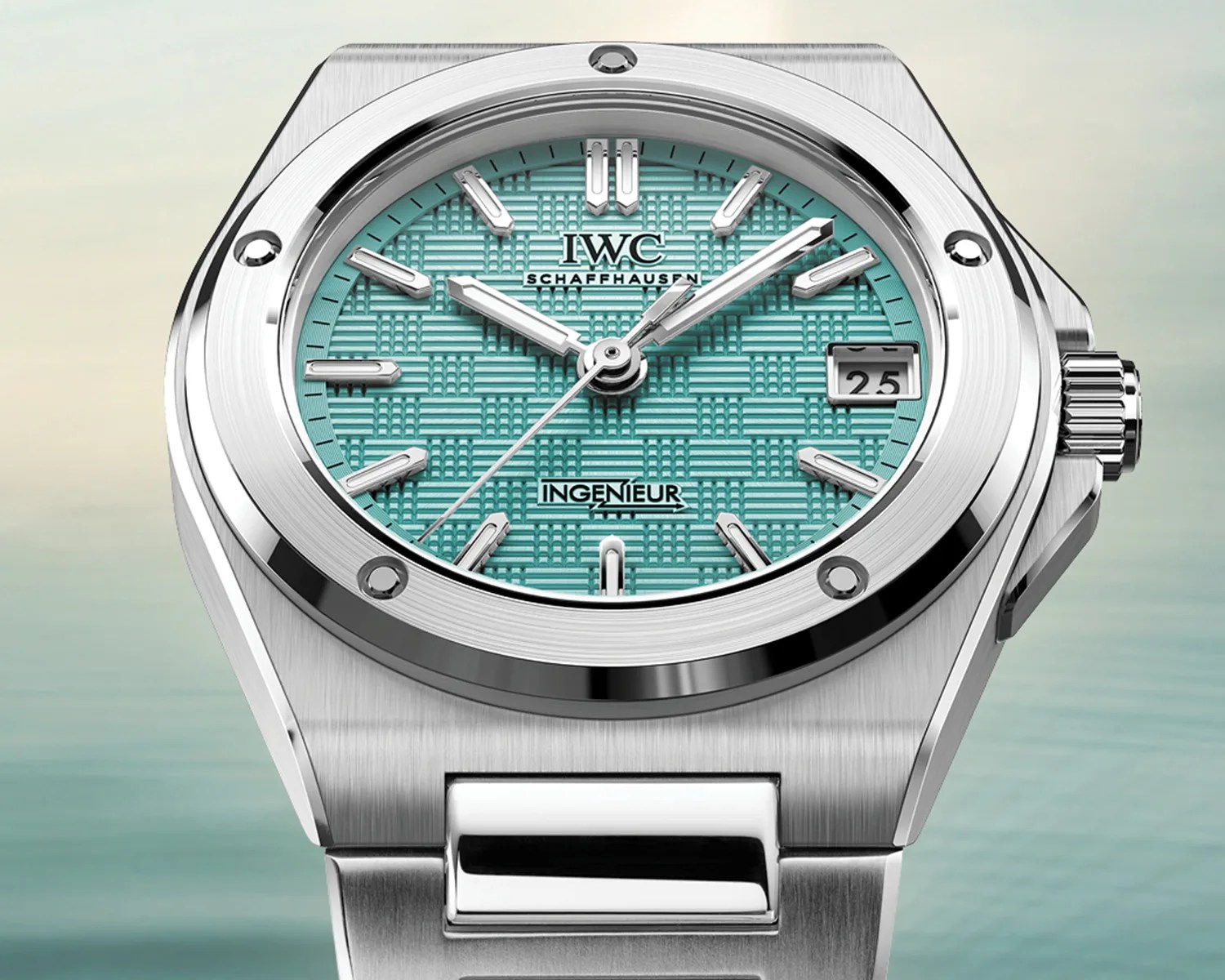 Silver IWC Ingenieur wristwatch with a textured turquoise dial and date display at 3 o'clock.