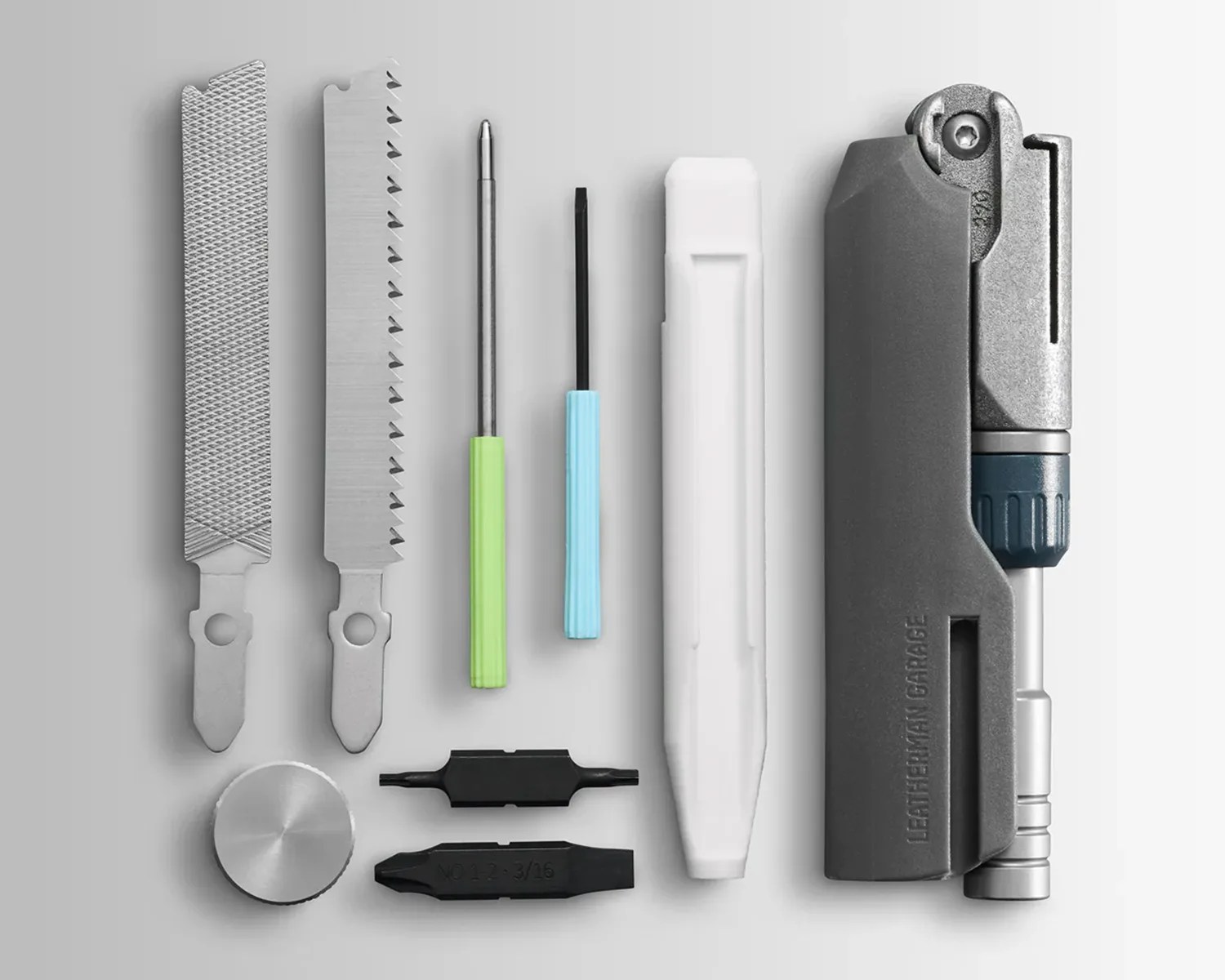 Set of metal and plastic multitool components including files, screwdrivers, bits, and a gray handle with "LEATHERMAN GARAGE" embossed.