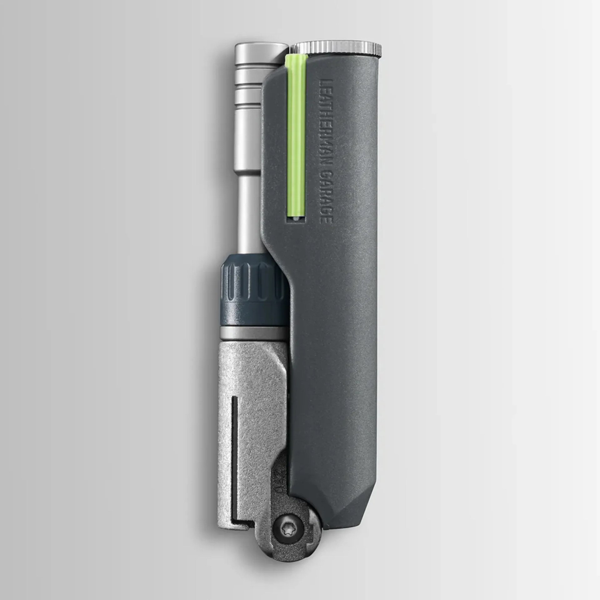 Compact gray and silver multi-tool with a green accent and "LEATHERMAN GARAGE" embossed on the side.