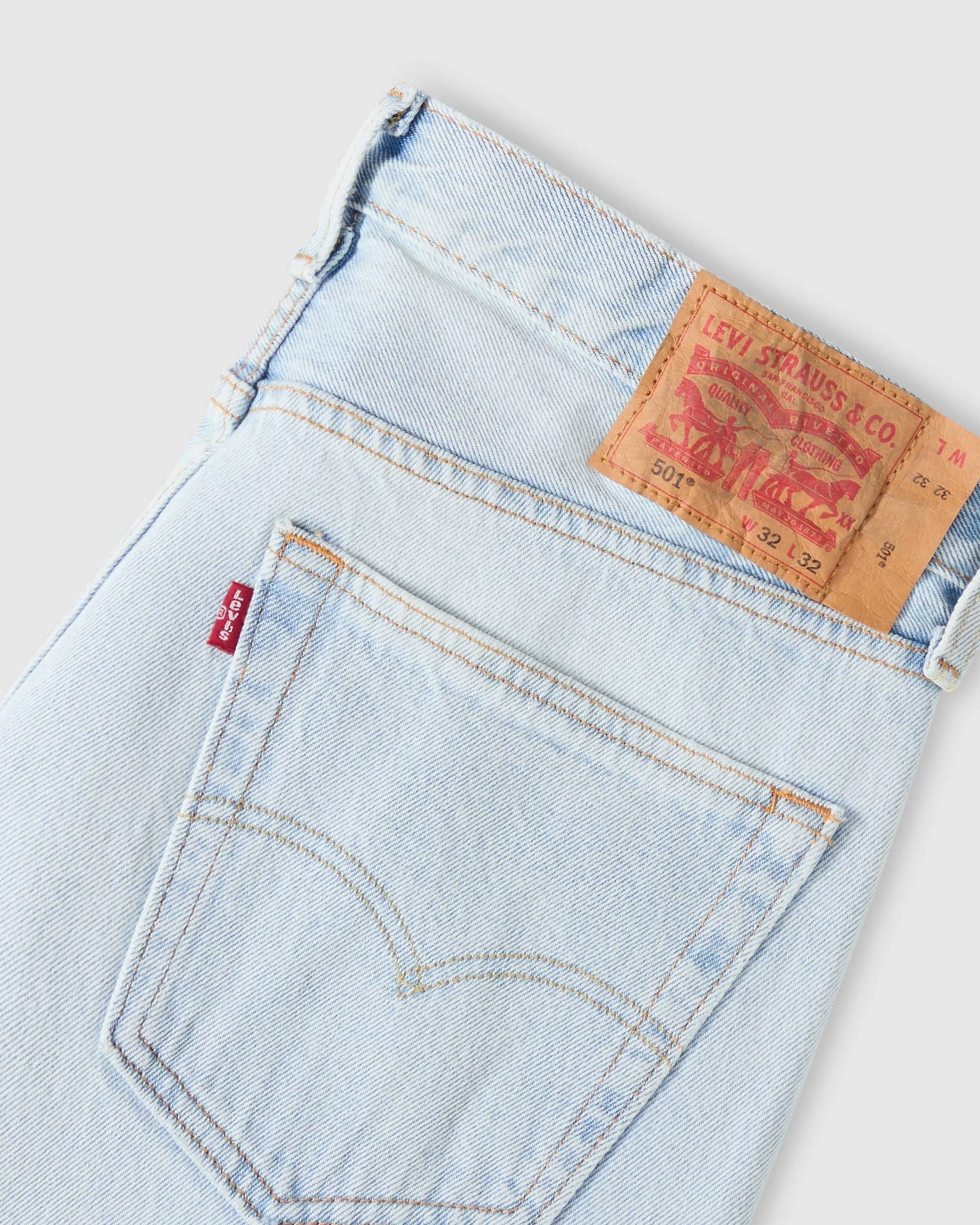 Light blue Levi's 501 jeans showing back pocket with red Levi's tag and brown leather brand patch.