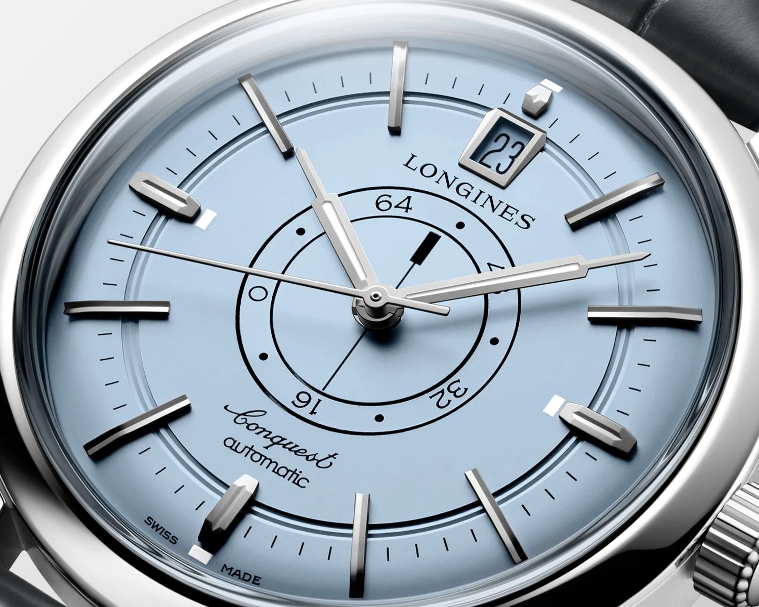 Close-up of a Longines Conquest Automatic watch with a light blue dial, silver hour markers, and a date window at 12 o'clock.