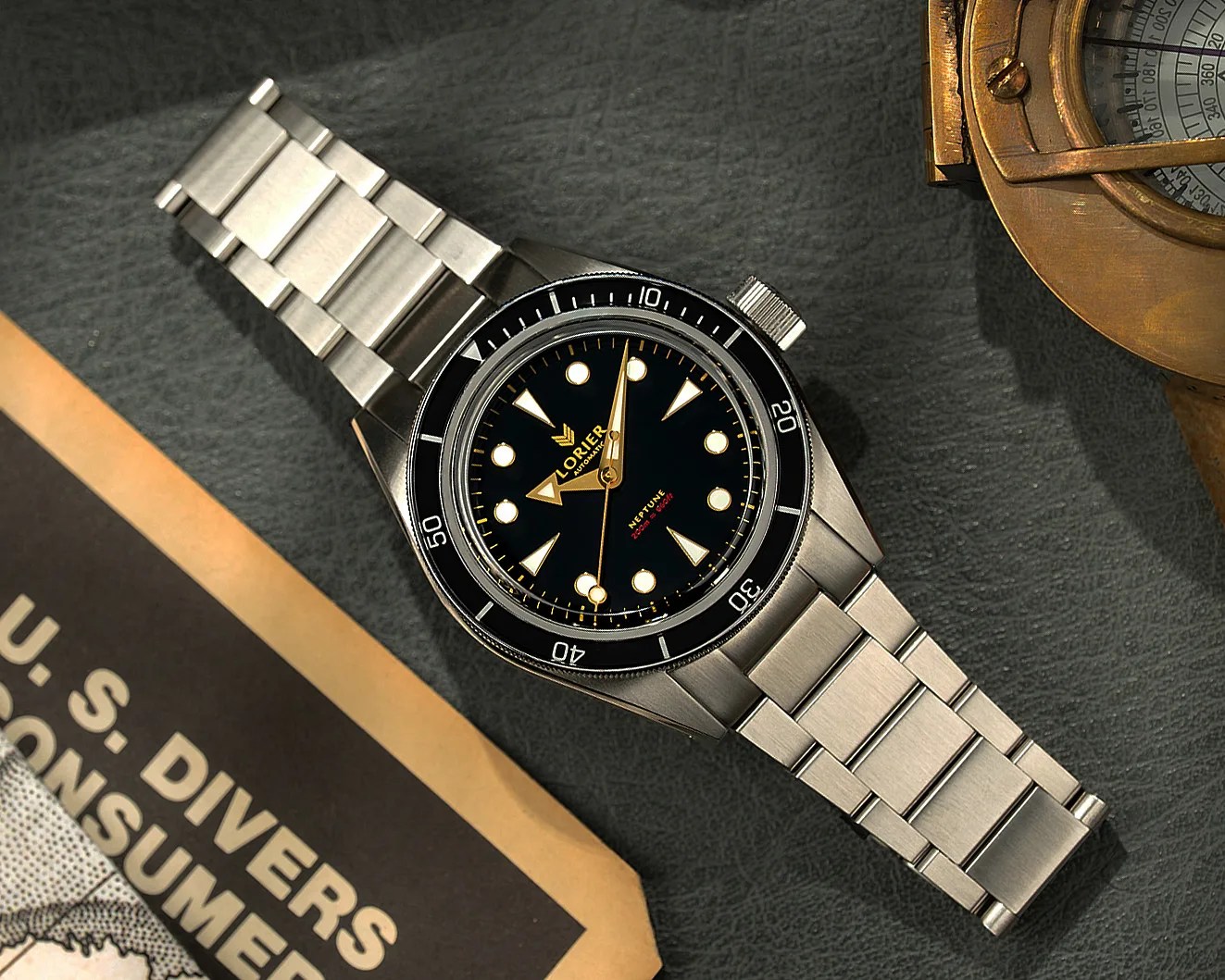 Stainless steel Lorier Neptune wristwatch with black dial and rotating bezel on a textured dark surface.