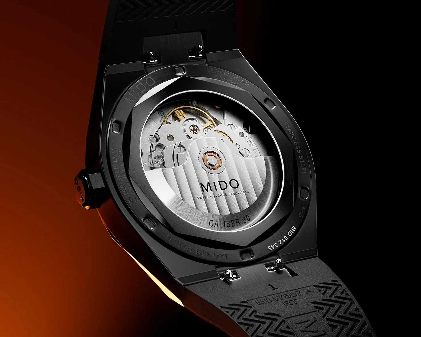 Back of a black Mido watch showing the Caliber 80 automatic movement through a sapphire crystal case back.