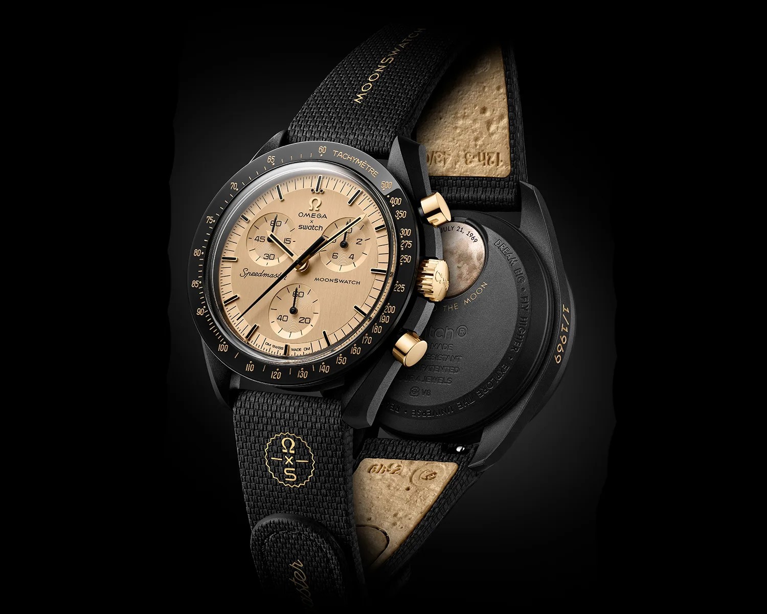 Black and gold Omega x Swatch MoonSwatch with tachymeter bezel and black rubber strap showing front and back.