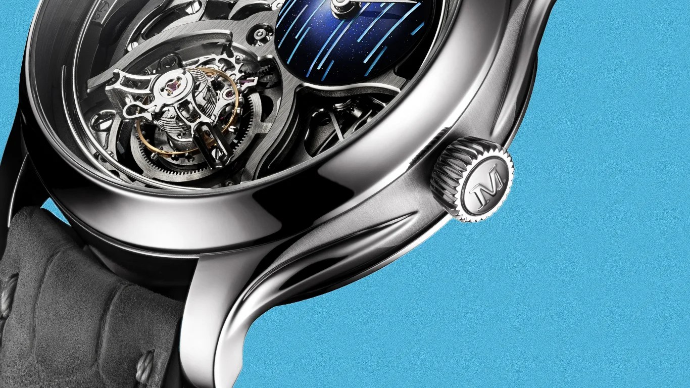 Close-up of a luxury mechanical watch with a polished silver case, visible gears, and a black leather strap against a blue background.