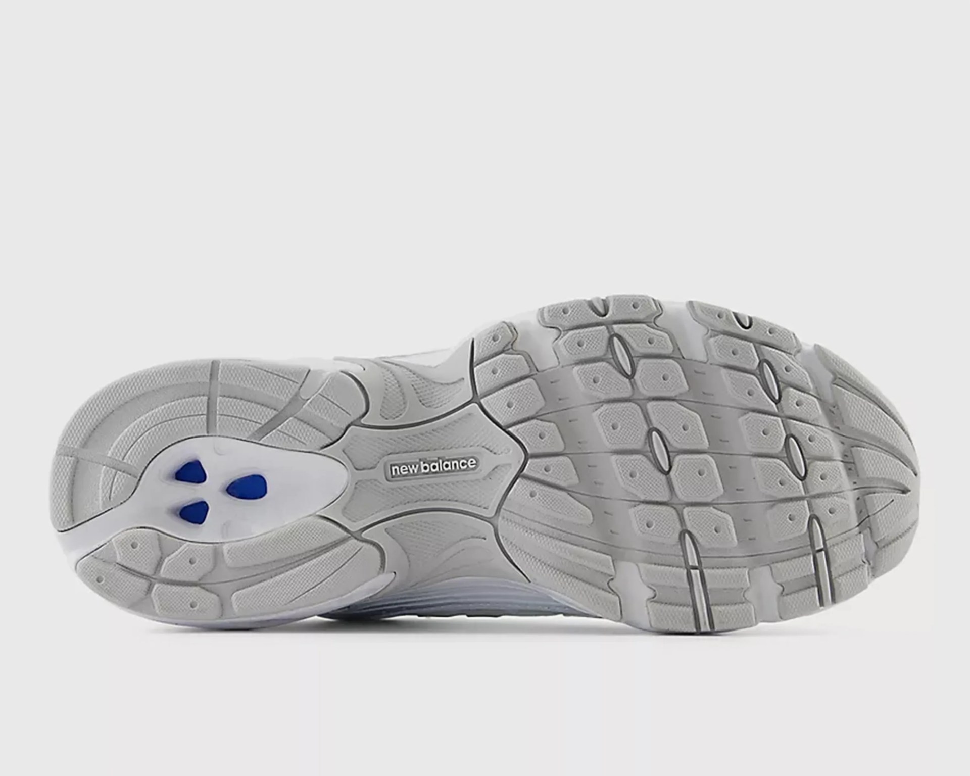Gray and white New Balance sneaker sole with blue accents and textured tread pattern.