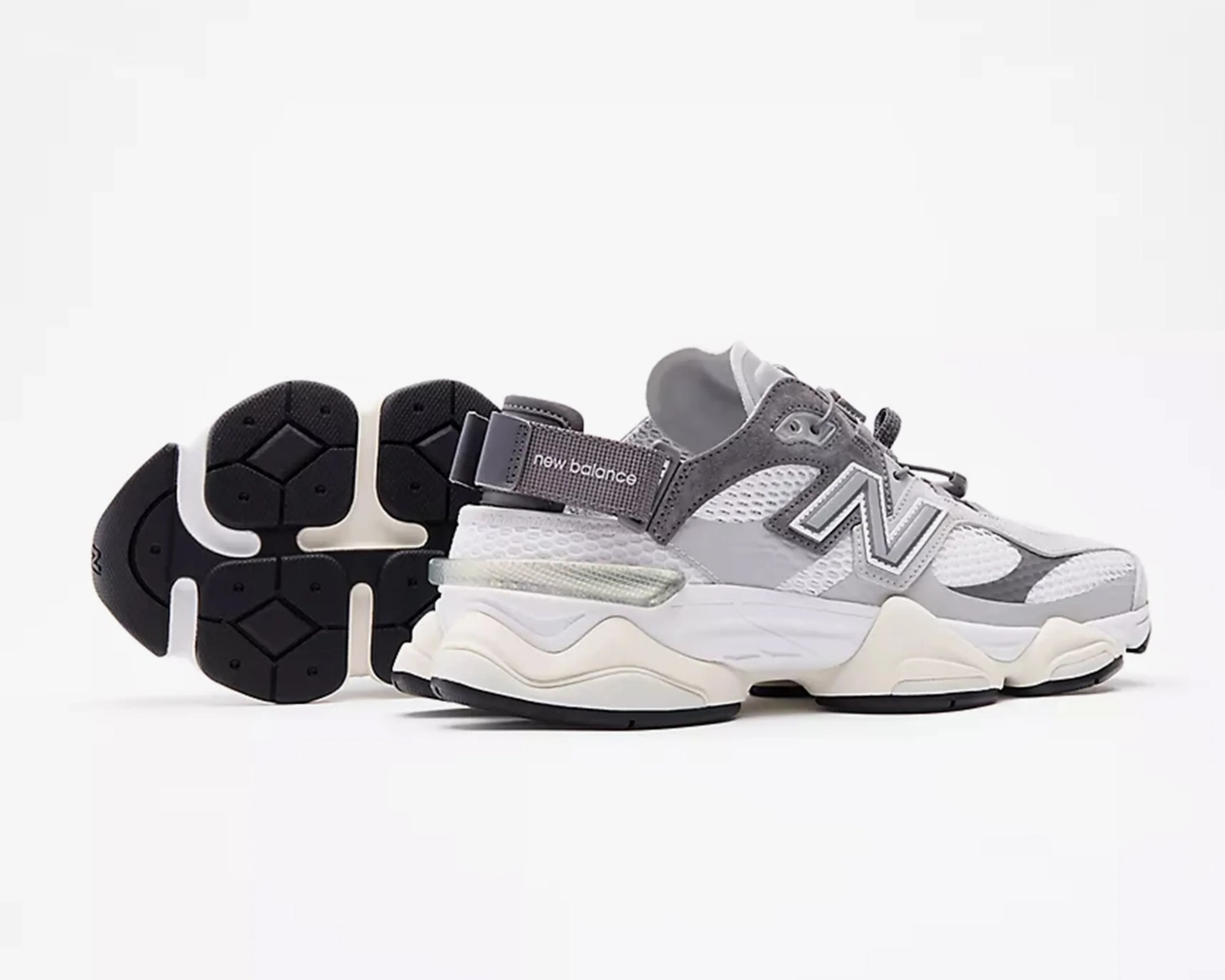 Gray and white New Balance sneaker with mesh and suede upper and chunky sole, shown from side and bottom.