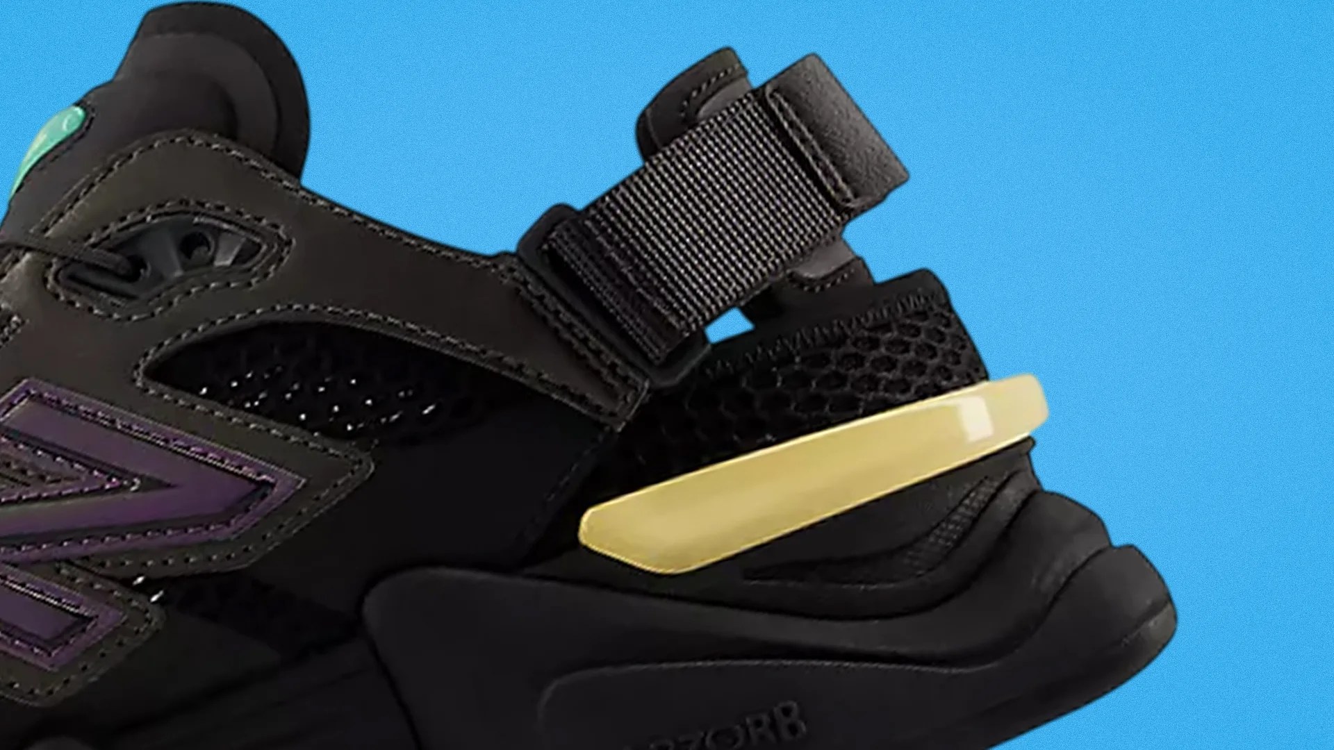 Close-up of a black sneaker with purple accents, mesh panels, a yellow heel clip, and a black strap against a blue background.
