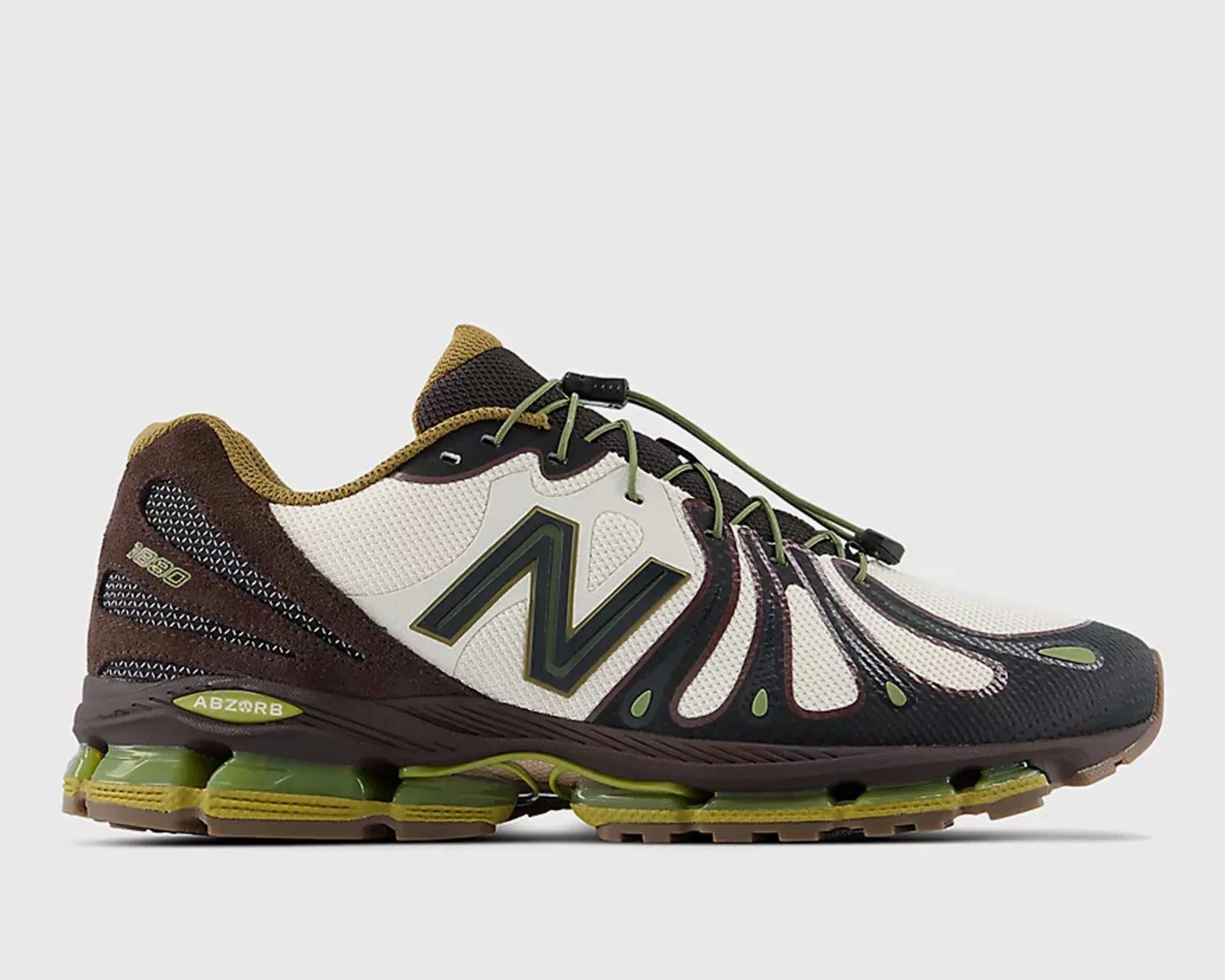 Brown, beige, and black New Balance running shoe with green accents and visible cushioning in the sole.