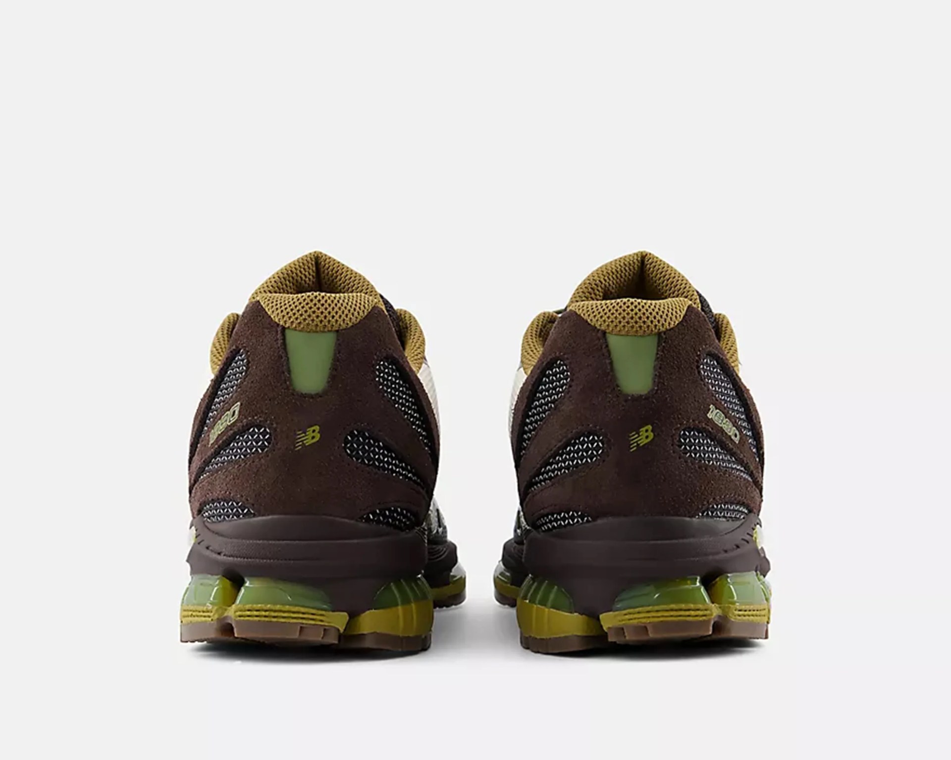 Pair of brown and olive green New Balance sneakers shown from the back on a white background.