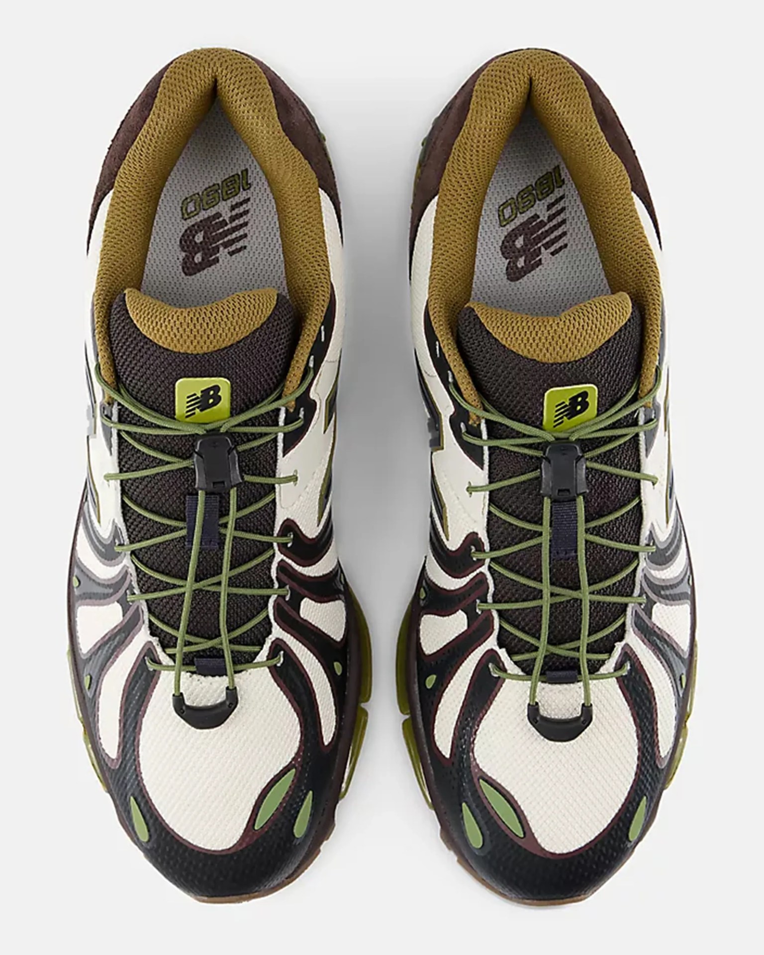 Pair of New Balance 1990 sneakers with olive green, black, and cream mesh uppers and quick-pull laces.