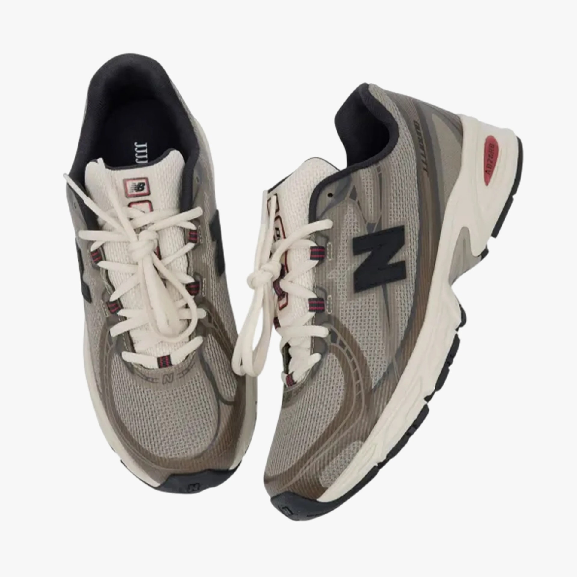 Pair of gray and beige New Balance running shoes with white laces and black "N" logo.