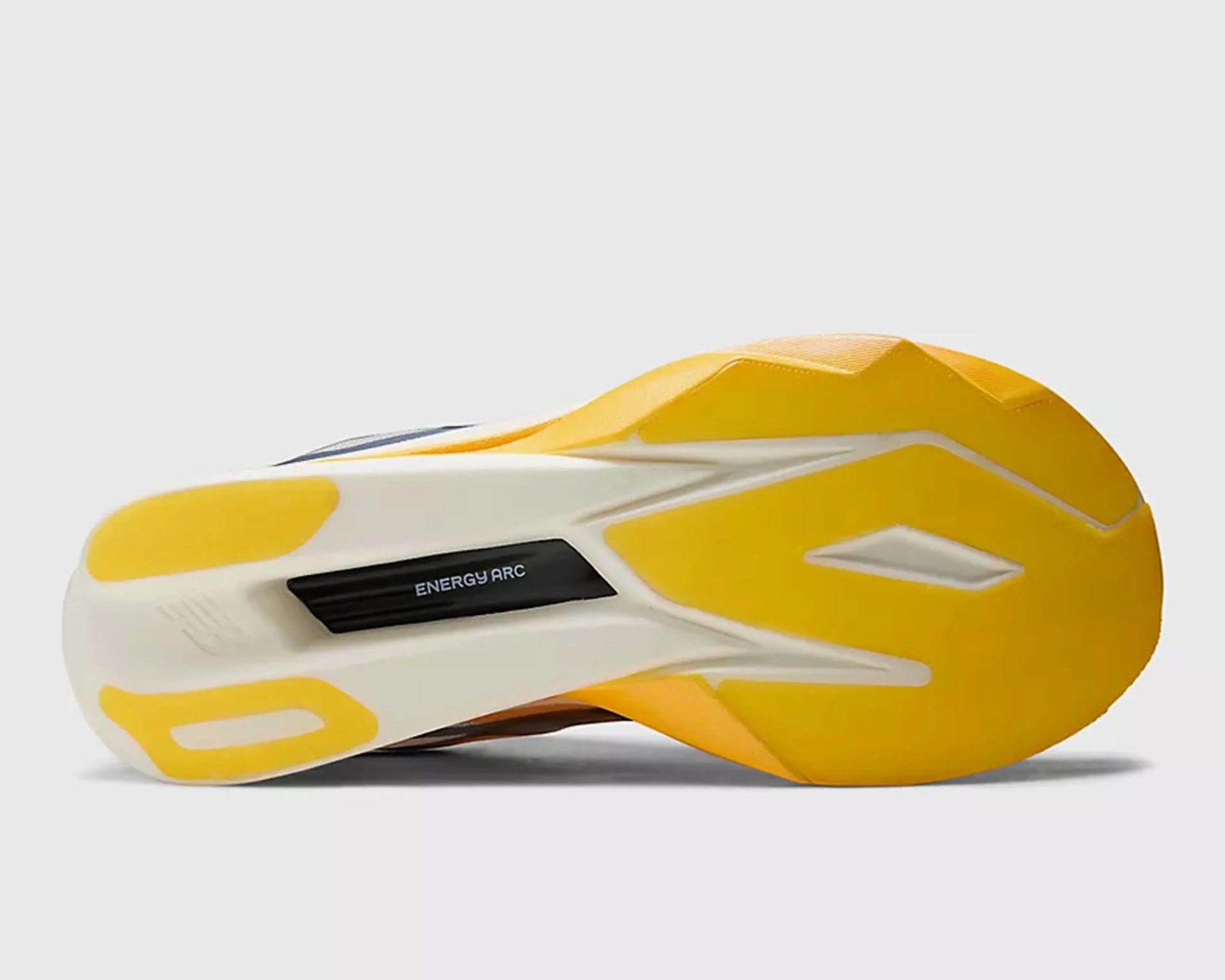 Yellow and white sneaker sole with black "ENERGY ARC" label on a gray background.