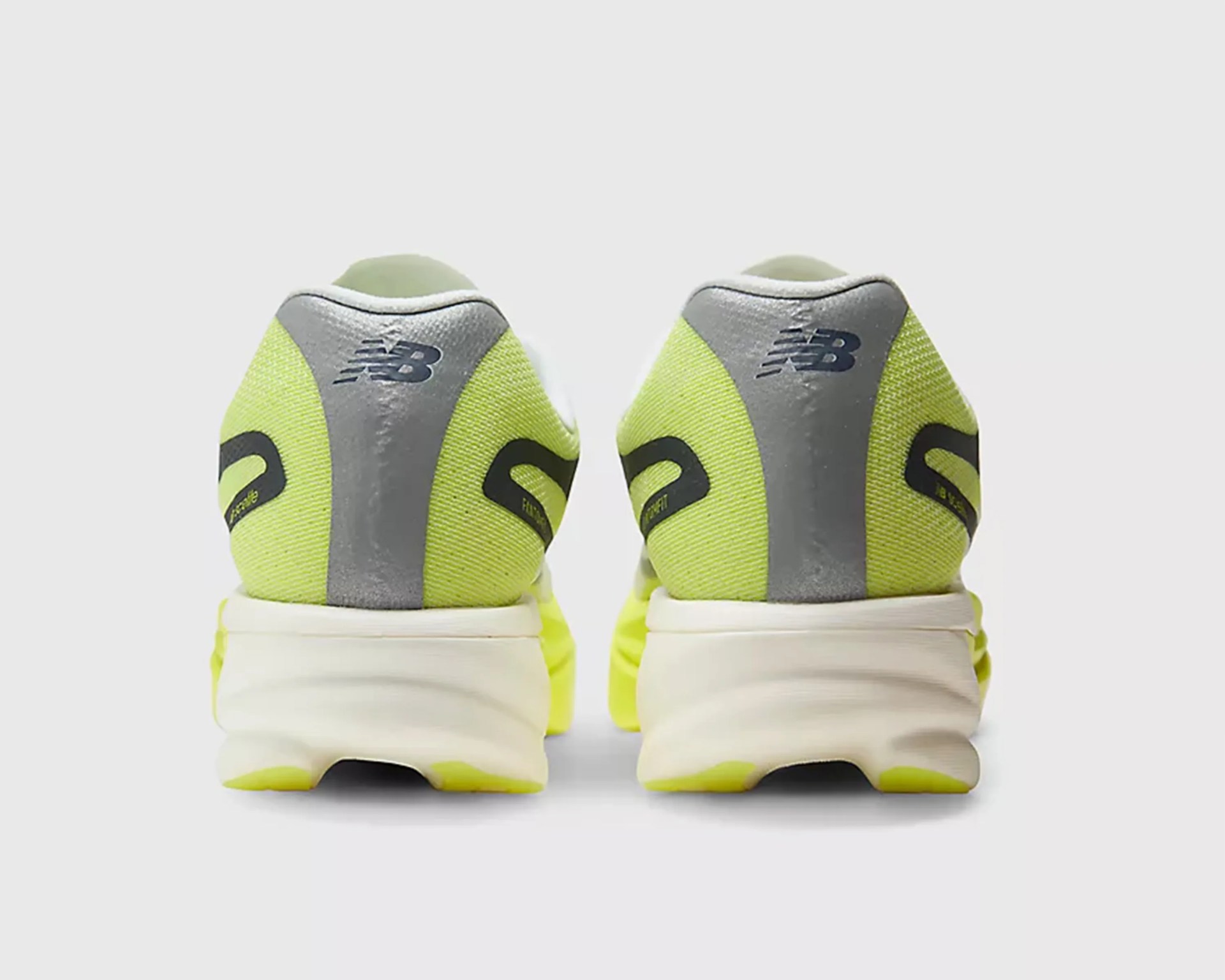 Pair of neon yellow and gray New Balance running shoes viewed from the back.