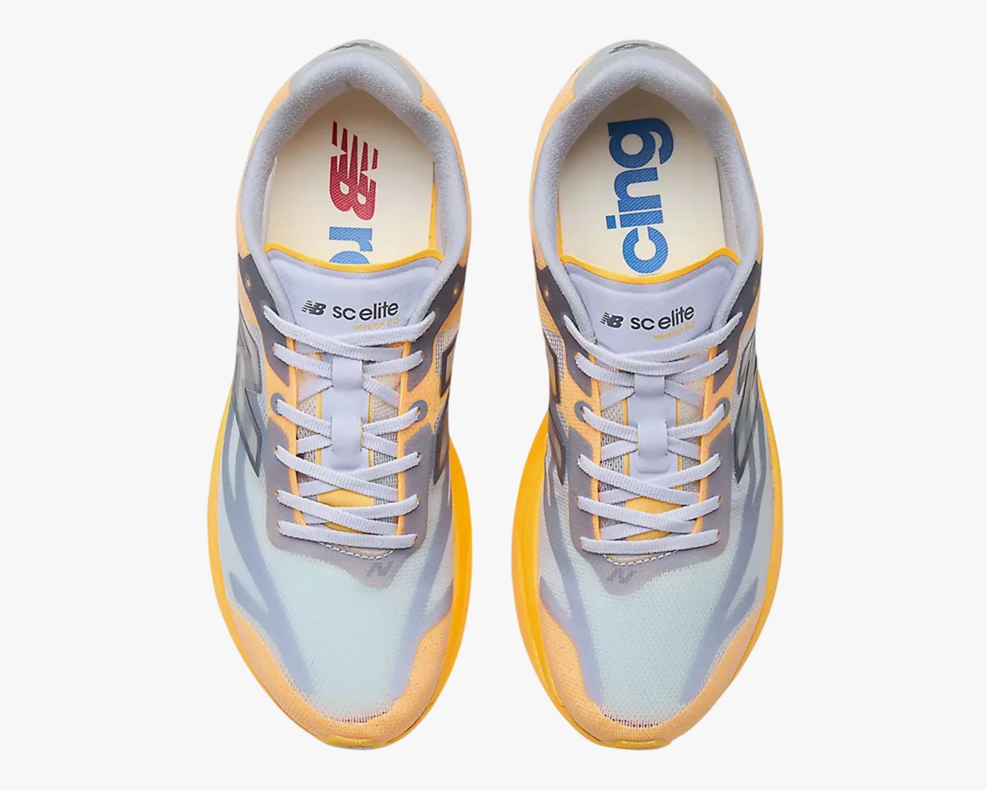 Pair of yellow and gray New Balance running shoes with white laces and branded insoles.