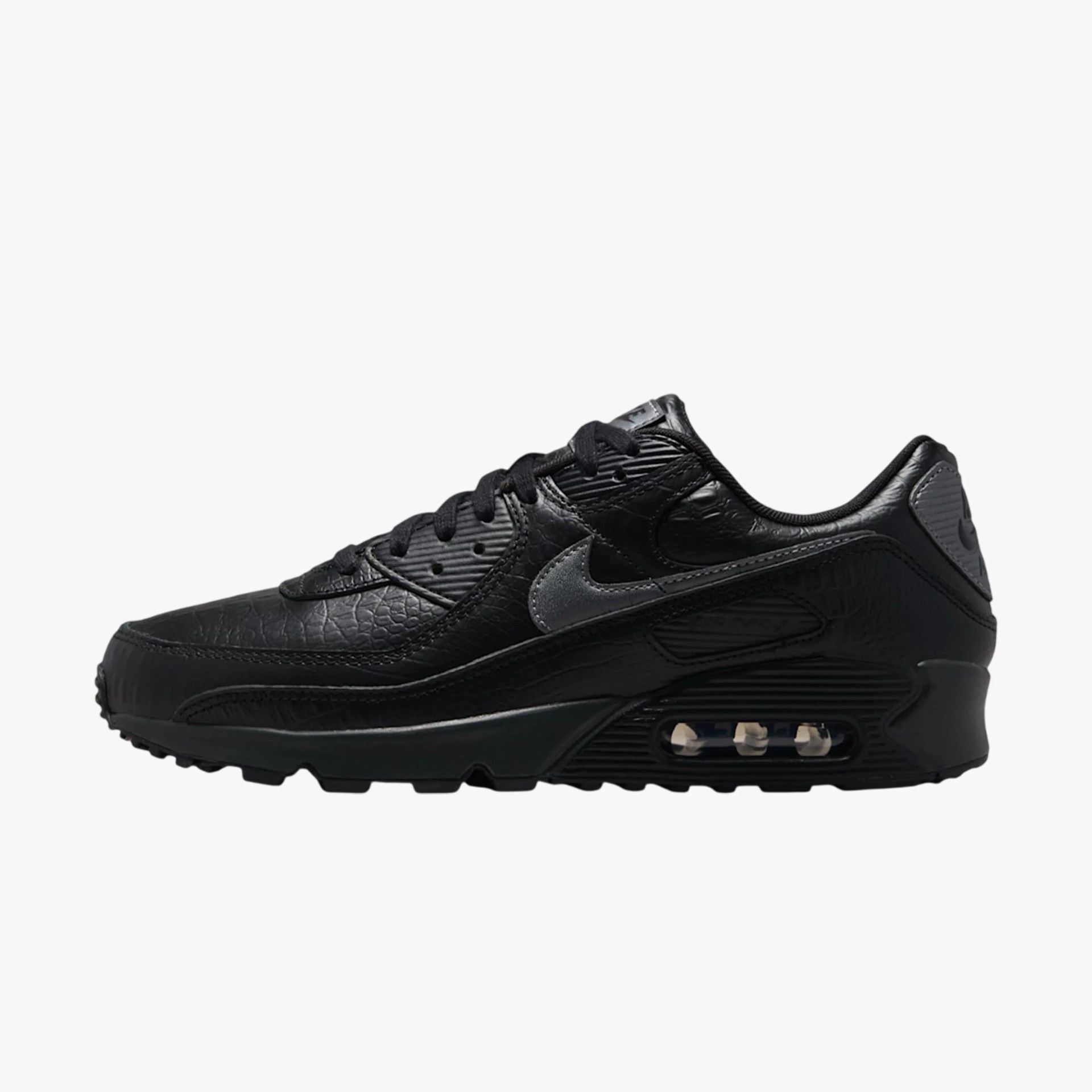 Black Nike Air Max sneaker with textured leather and visible air cushioning in the sole.