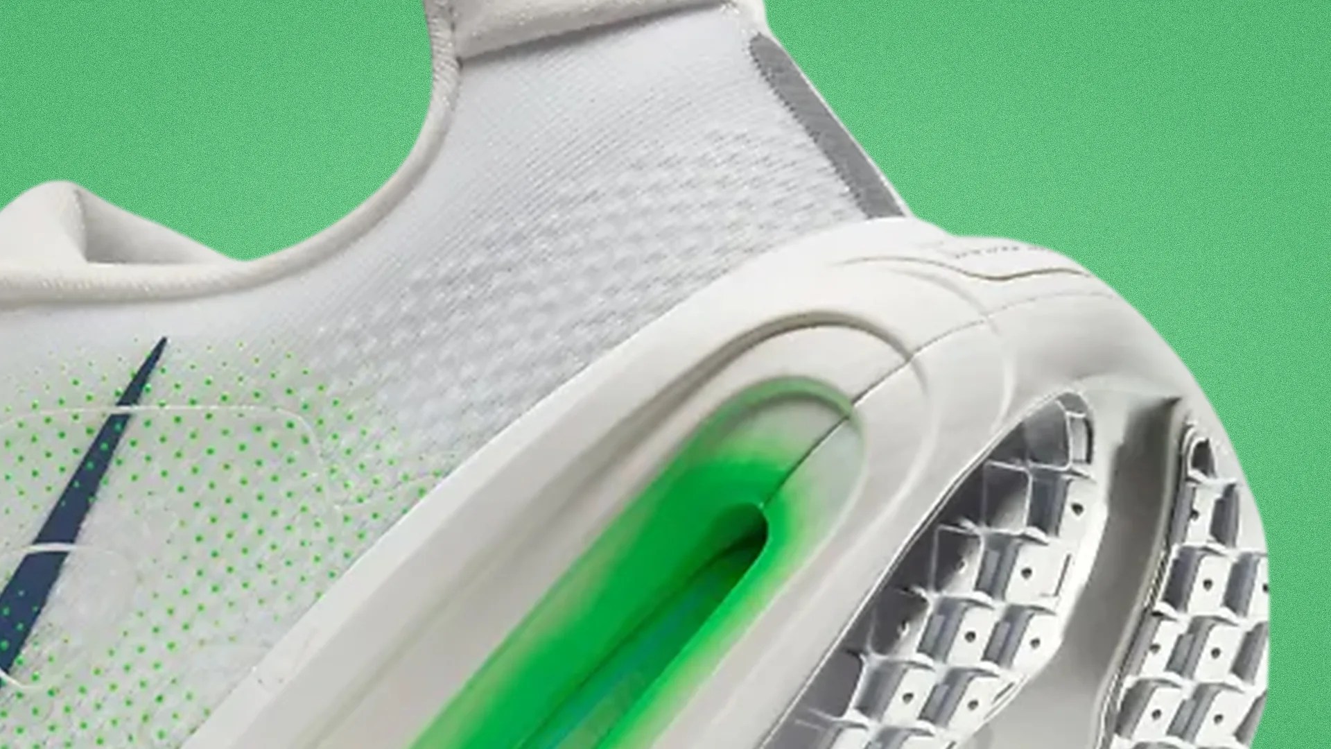Close-up of a white sneaker with a visible green air cushion in the sole and a blue swoosh logo on the side.