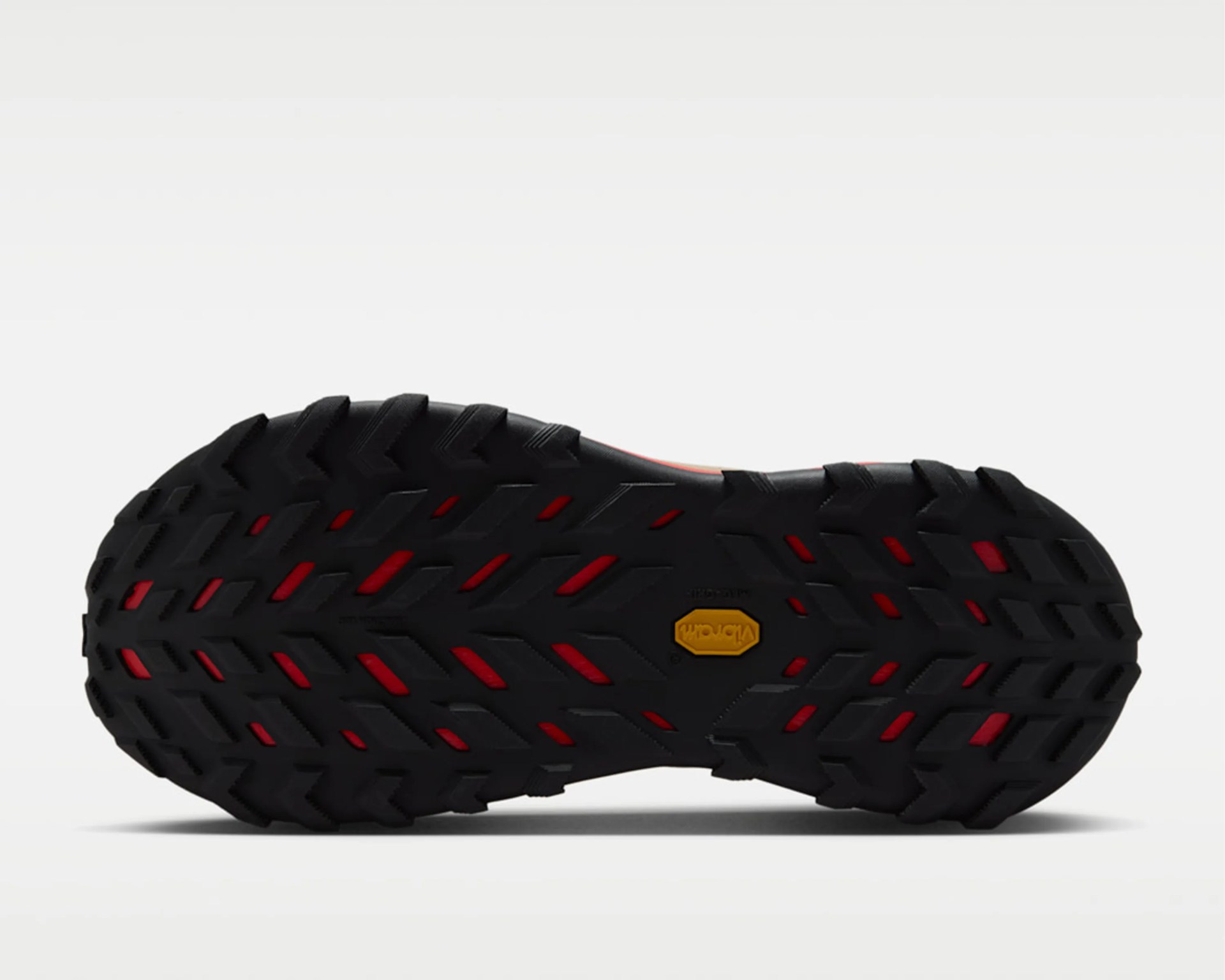 Black and red Vibram rubber shoe sole with deep tread pattern on a white background.