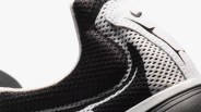 Close-up of a black and white Nike sneaker with mesh fabric and a visible Nike swoosh logo.