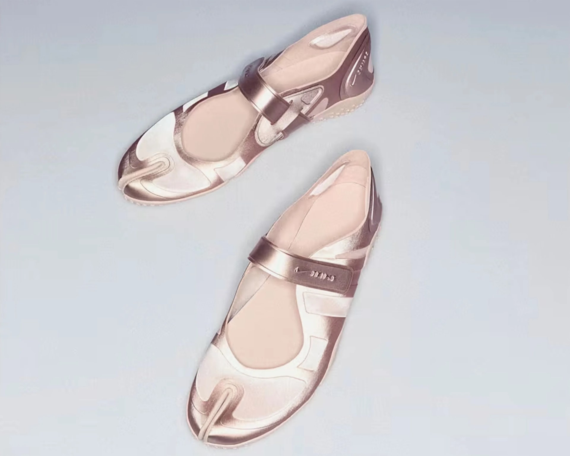 Pair of metallic rose gold split-toe sandals with adjustable straps on a light gray surface.