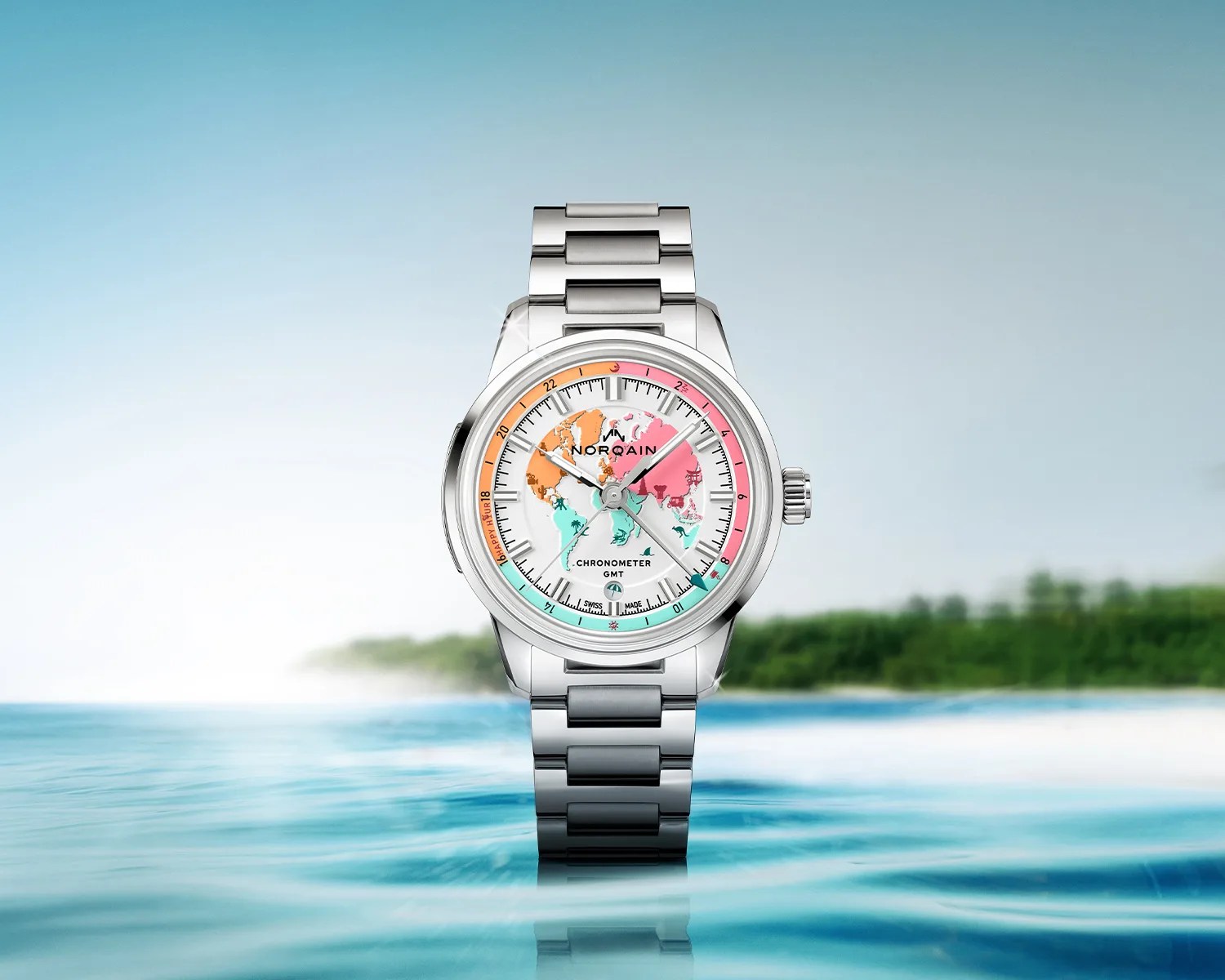 Silver metal wristwatch with a colorful world map dial and GMT chronometer markings, set against a water and sky background.