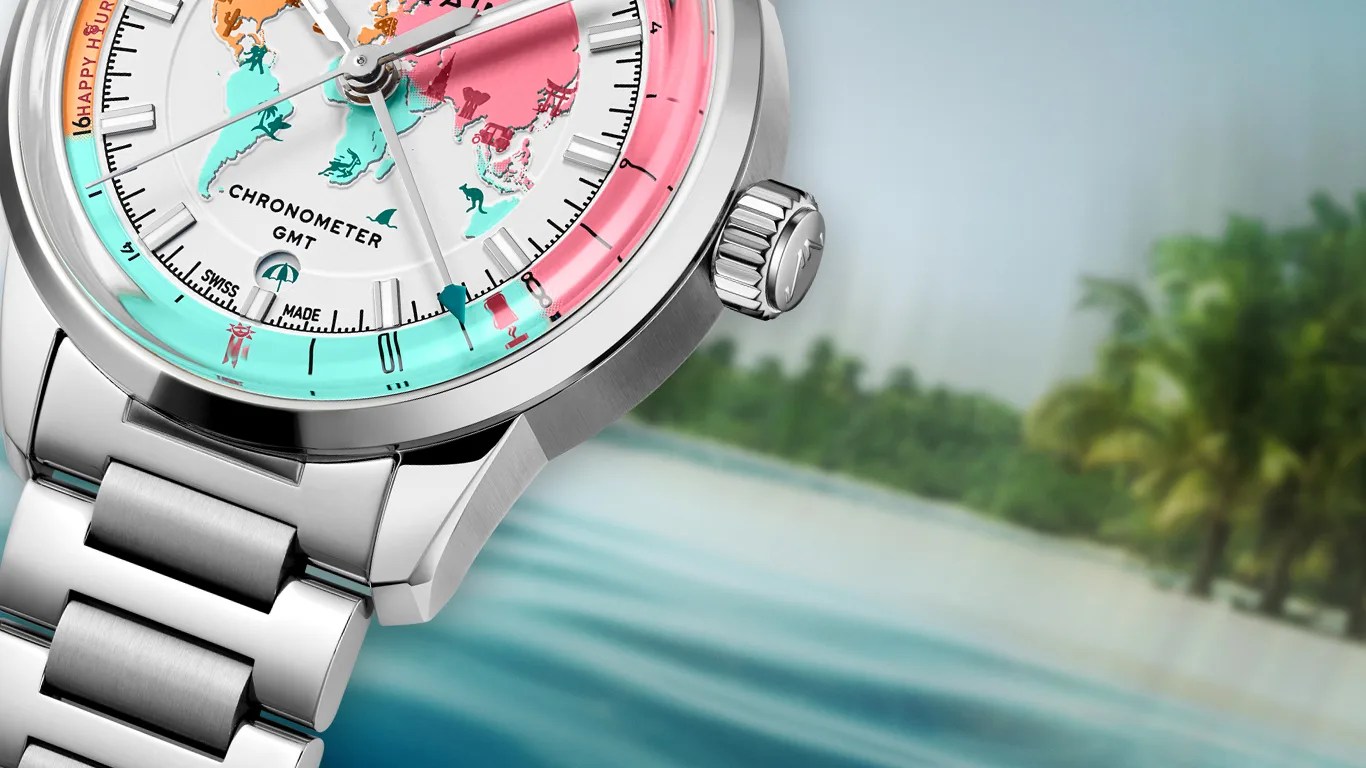 Close-up of a silver metal chronometer GMT wristwatch with a colorful world map dial and a stainless steel bracelet.