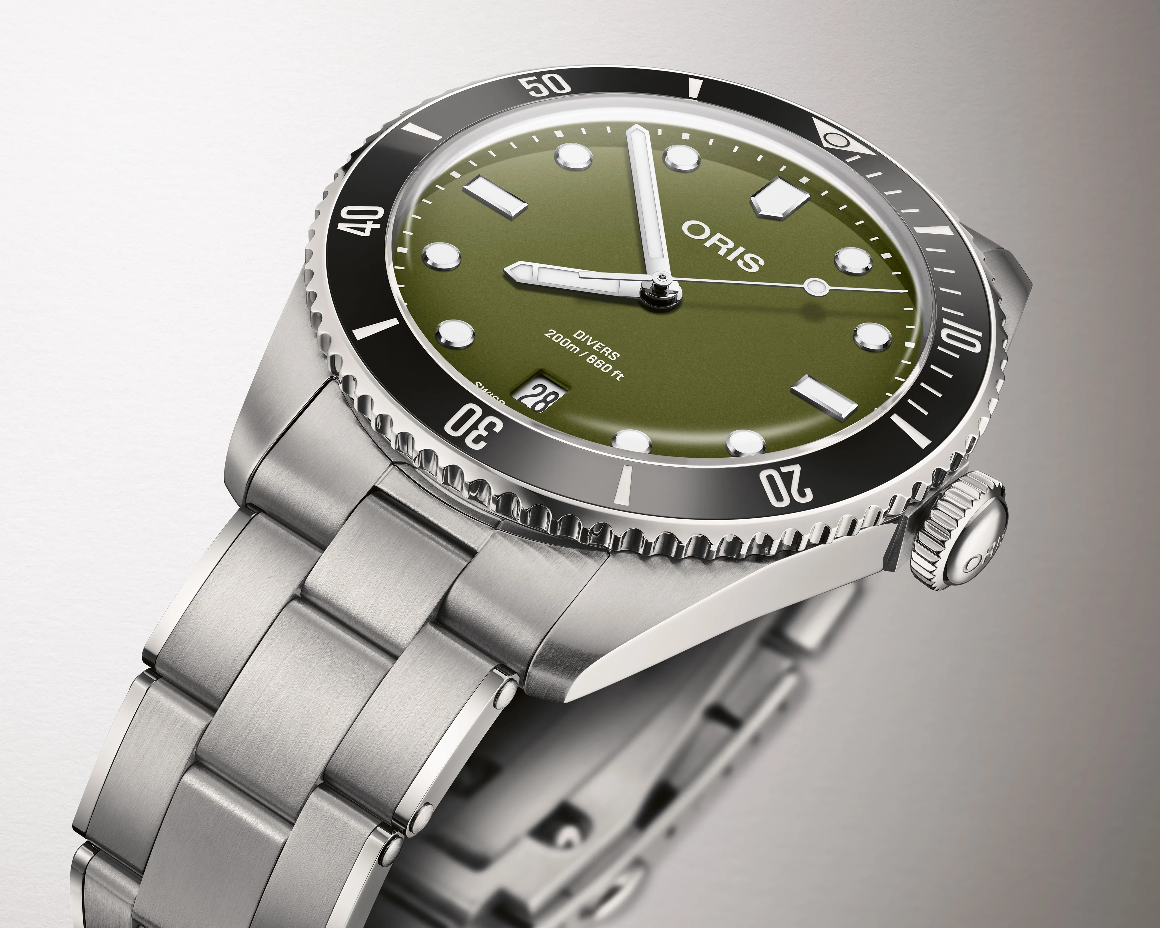 Stainless steel Oris diver's watch with olive green dial, black bezel, and date window at 6 o'clock.