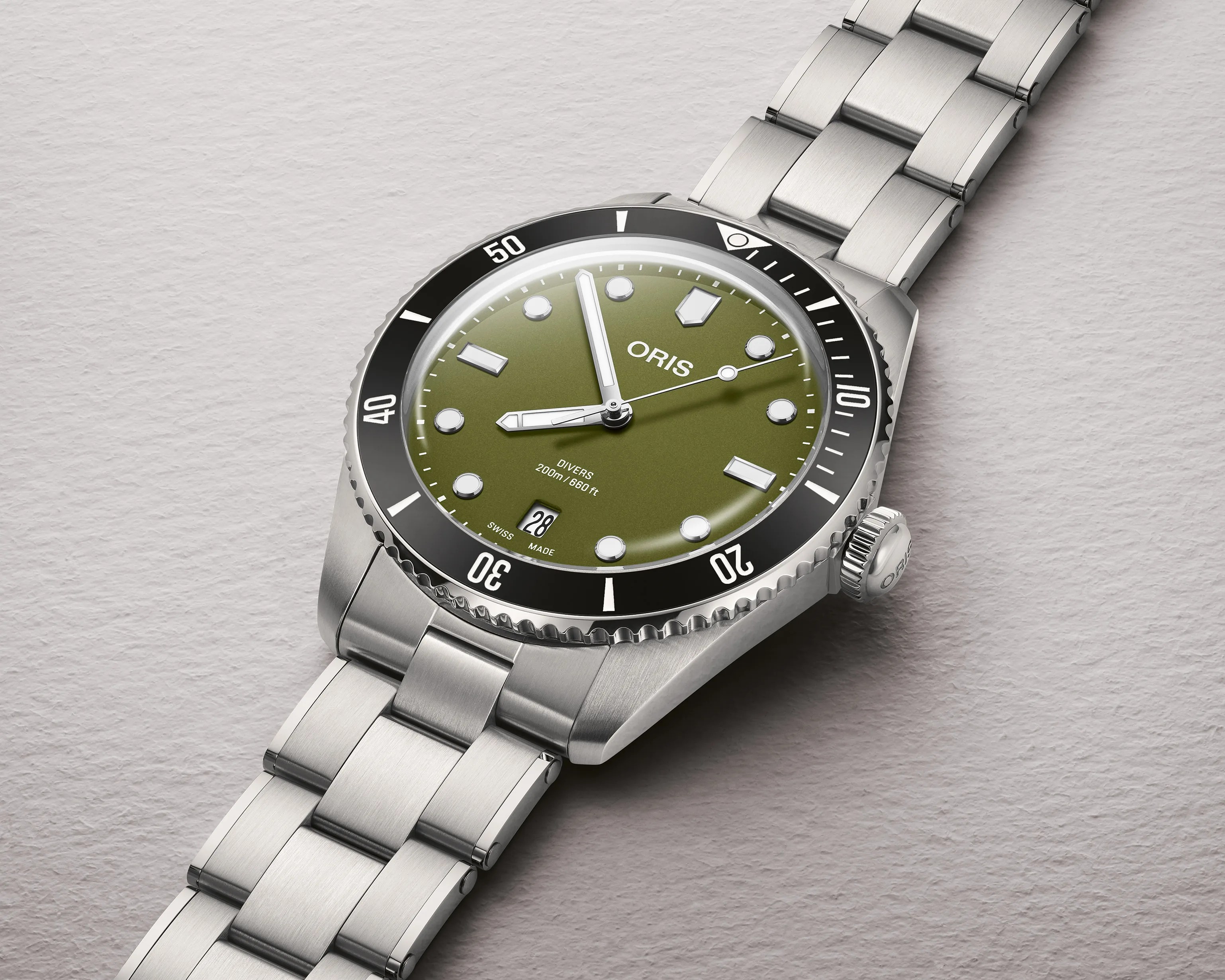 Stainless steel diver's watch with olive green dial, black bezel, and date window at 6 o'clock.