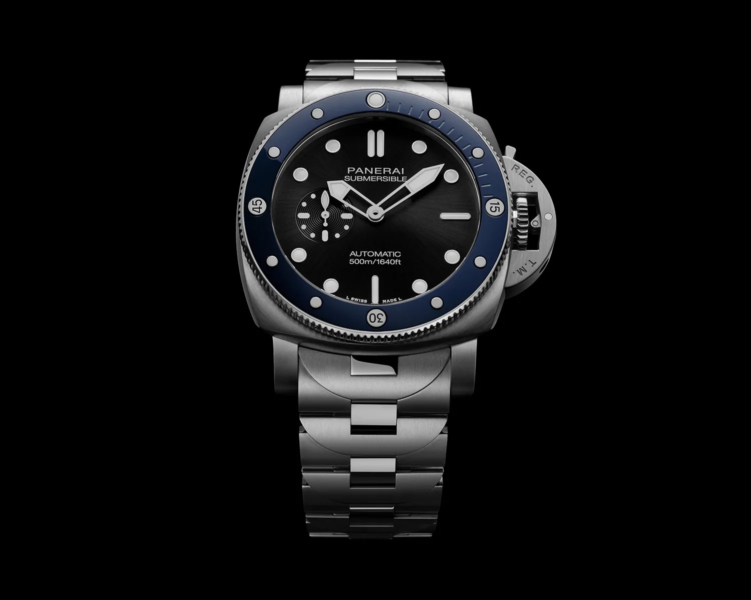 Stainless steel Panerai Submersible watch with black dial, blue bezel, and metal bracelet on black background.