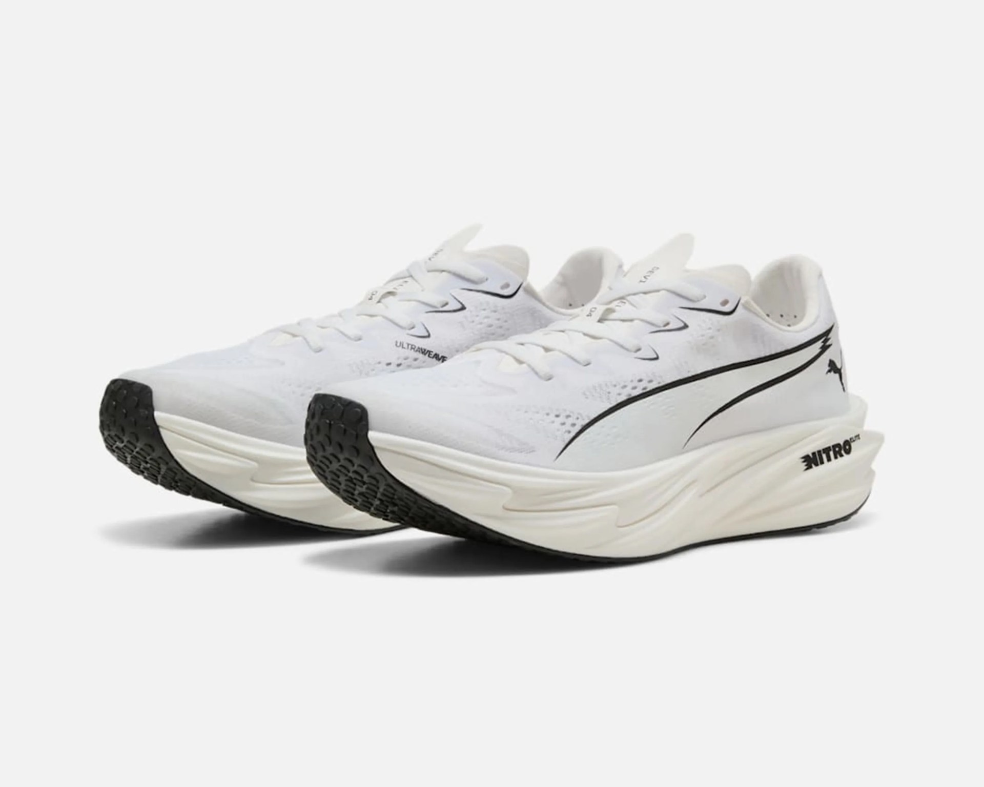 Pair of white Puma running shoes with black soles and Nitro cushioning midsoles.