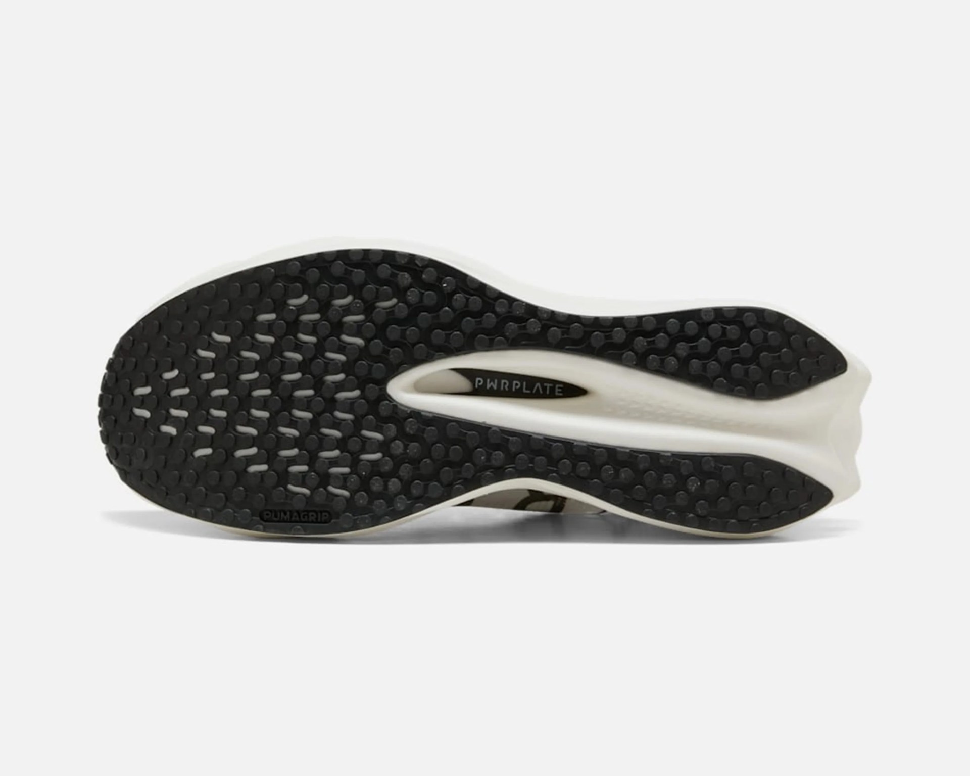 Black and white Puma shoe sole with PWRPLATE and PUMAGRIP text visible.