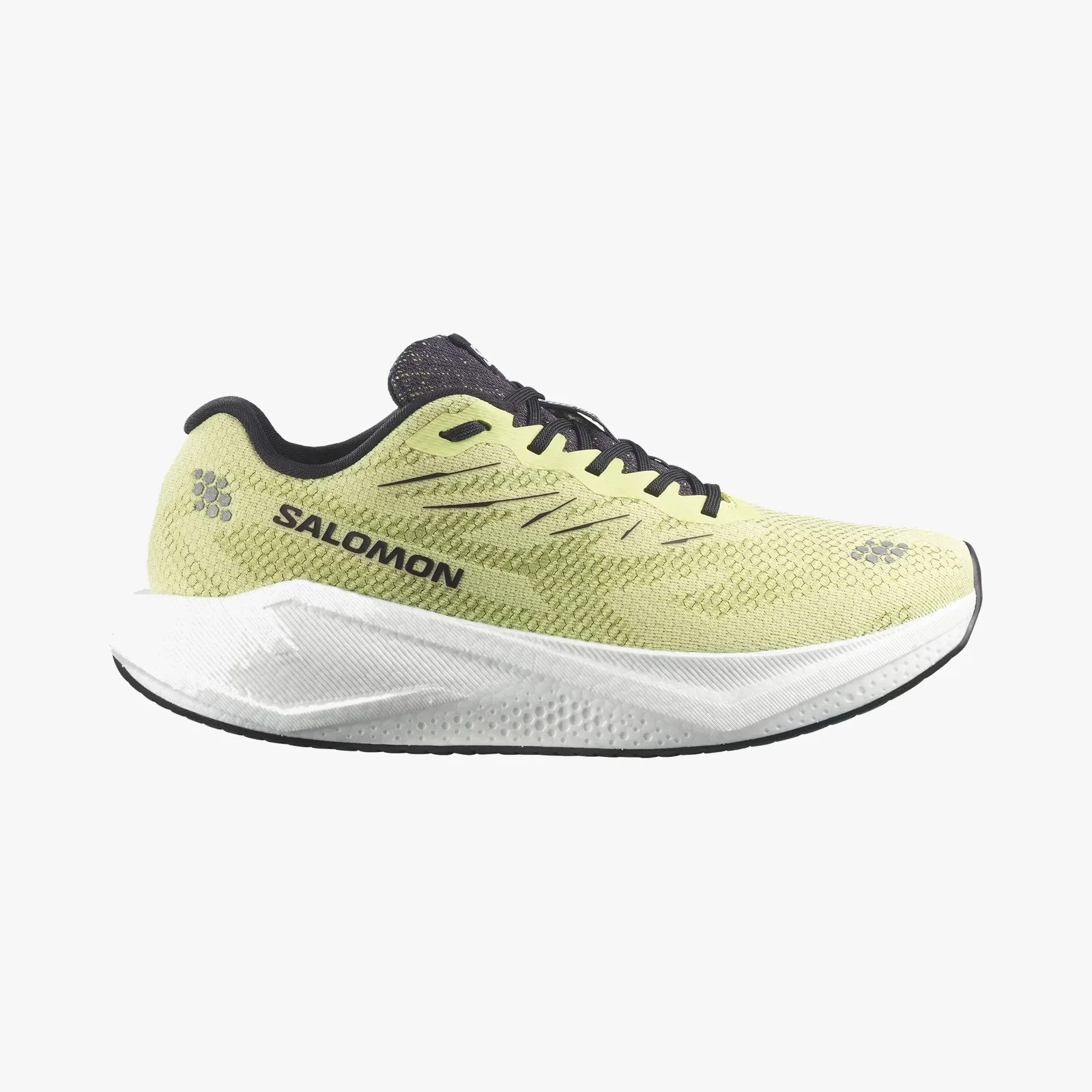 Light green and black Salomon running shoe with thick white sole and black laces.