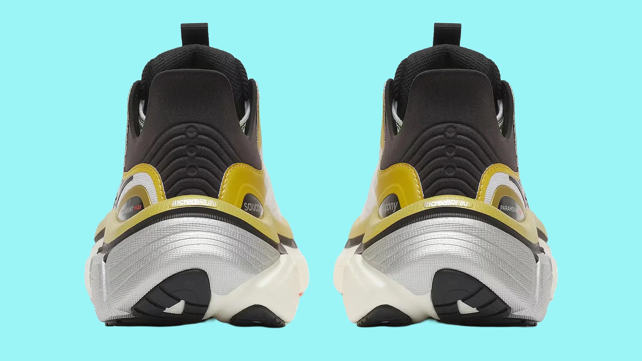 Pair of black, yellow, and silver Saucony running shoes shown from the back on a light blue background.
