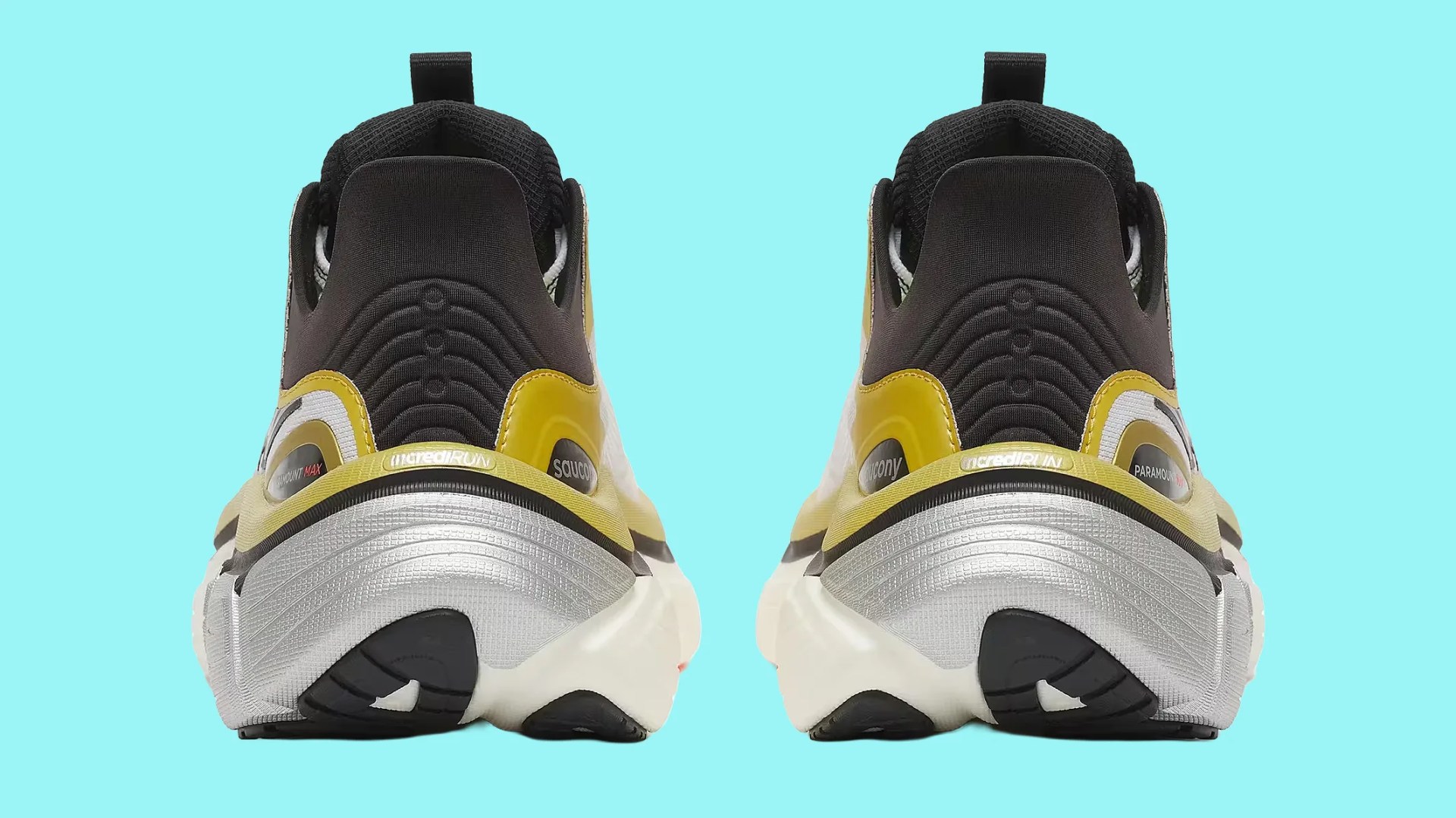 Pair of black, yellow, and silver Saucony running shoes shown from the back on a light blue background.