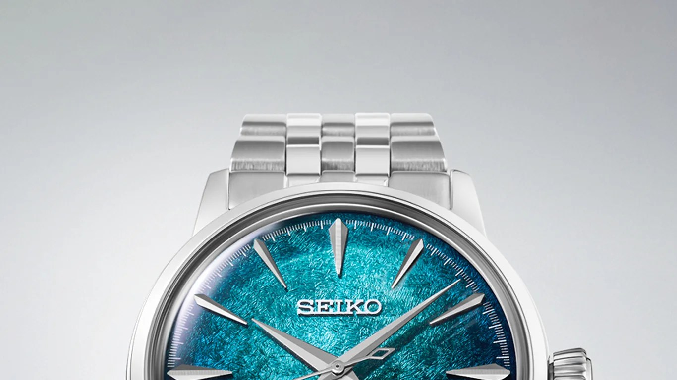 Silver Seiko wristwatch with a textured blue dial and silver hour markers and hands.