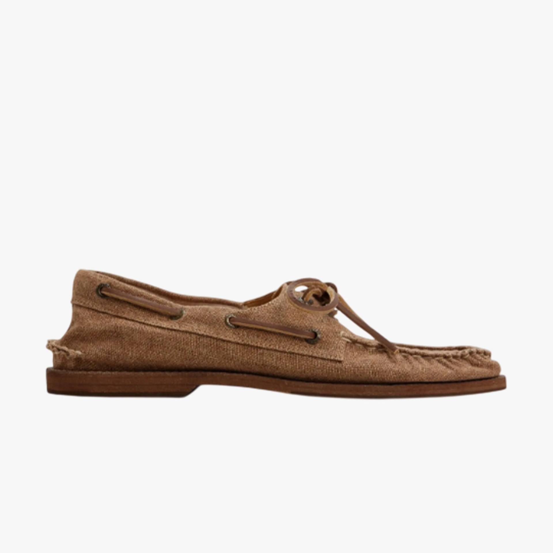Brown suede moccasin shoe with leather laces tied in a bow on top.