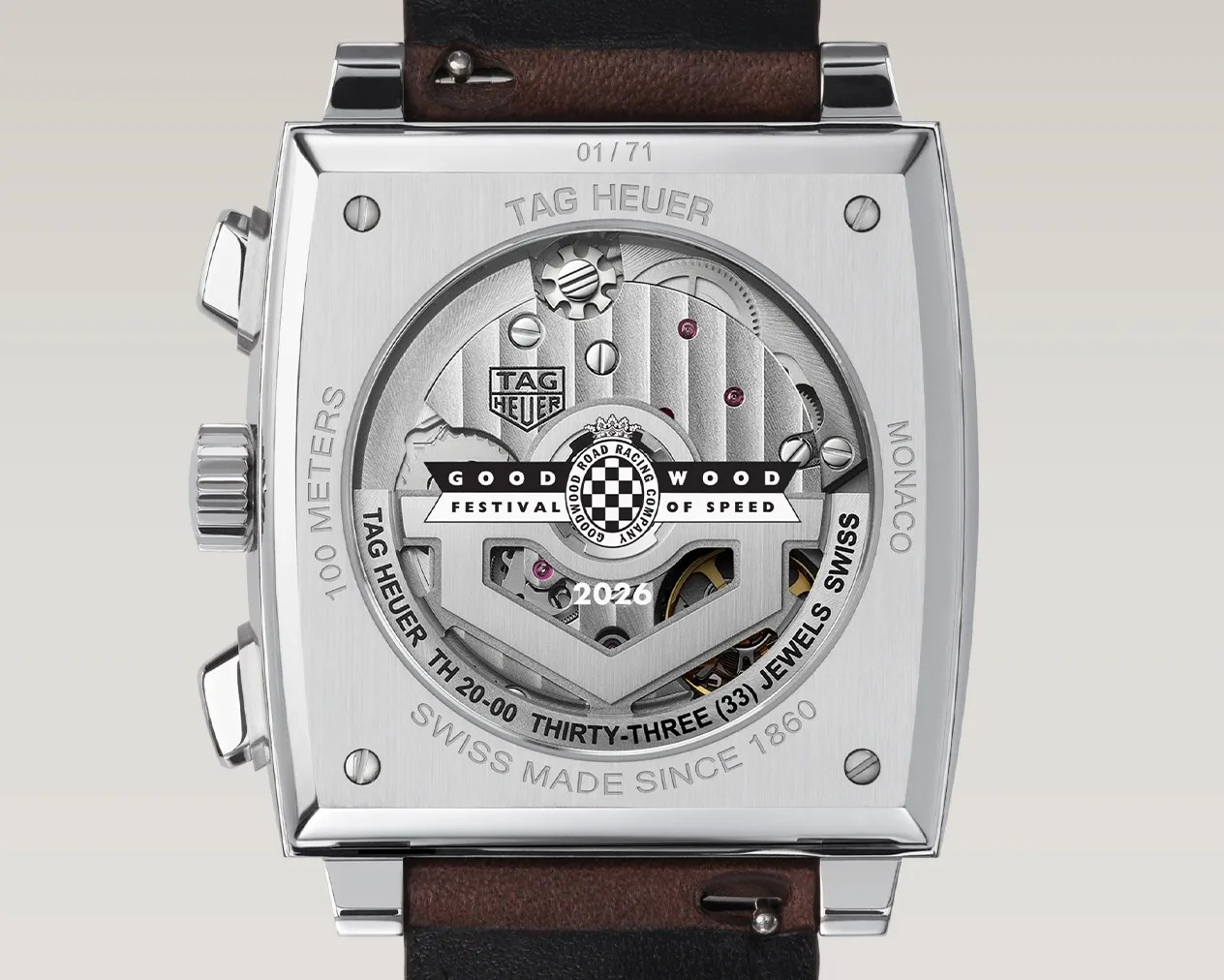 Back of a TAG Heuer Monaco watch with visible mechanical movement, engraved details, and Goodwood Festival of Speed 2026 logo.