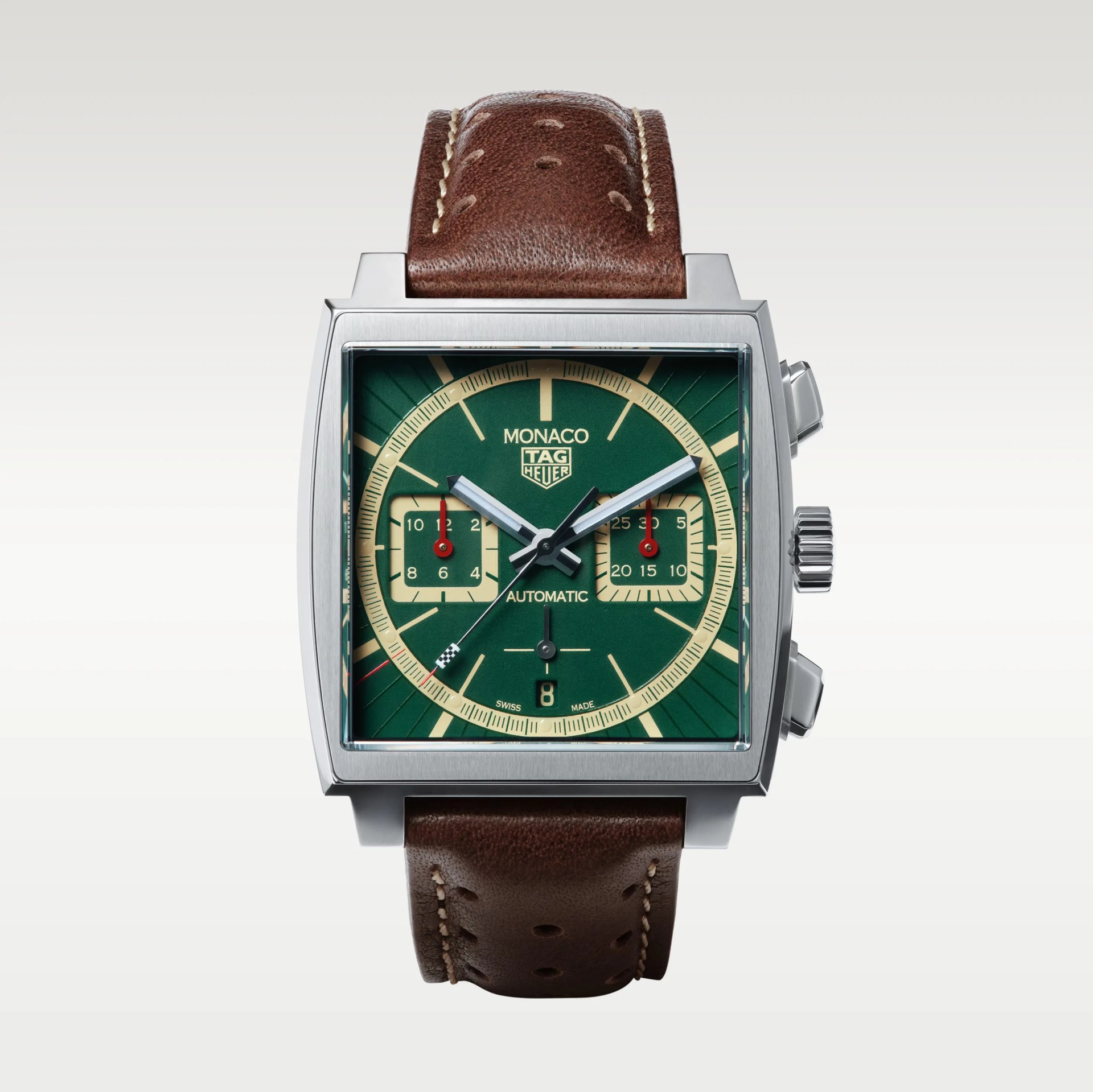 Square stainless steel TAG Heuer Monaco watch with green dial, cream subdials, and brown perforated leather strap.