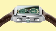 Square stainless steel TAG Heuer Monaco watch with green dial and brown perforated leather strap.