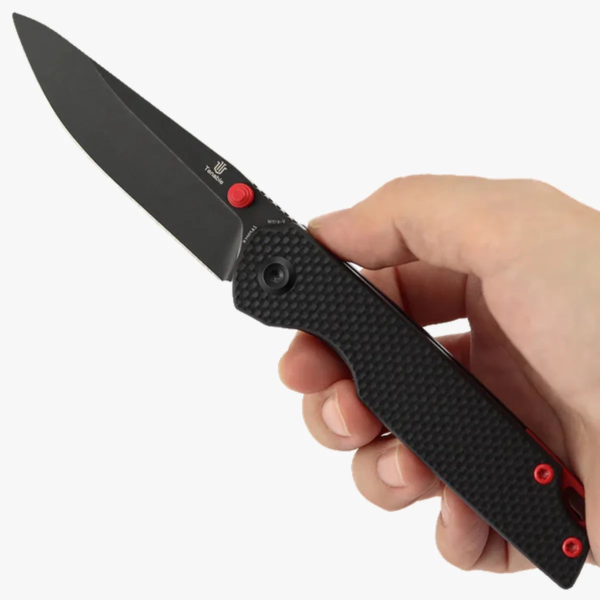 Hand holding a black folding knife with a textured handle and a red thumb stud on the blade.