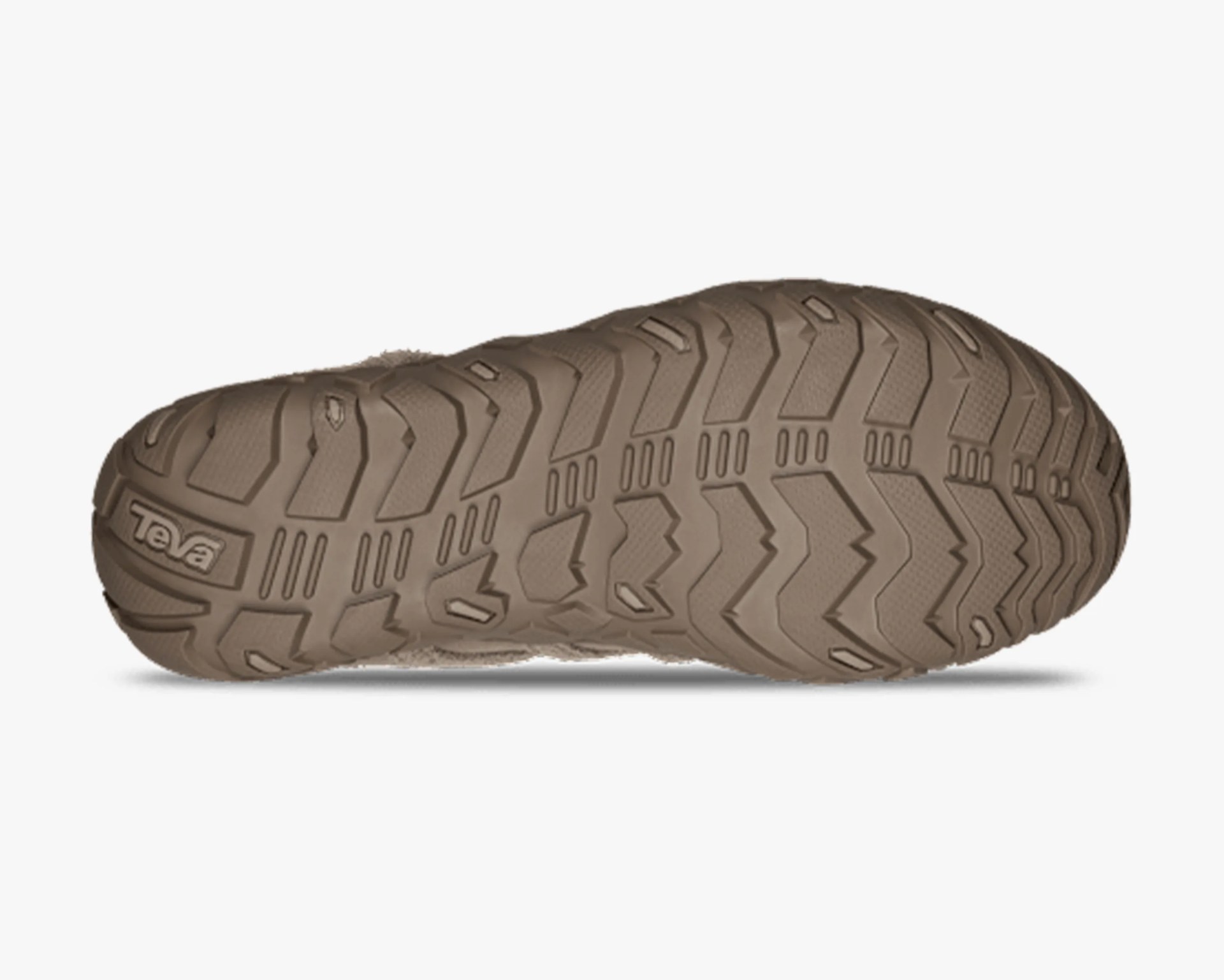 Brown rubber sole of a Teva shoe with deep tread patterns for traction.