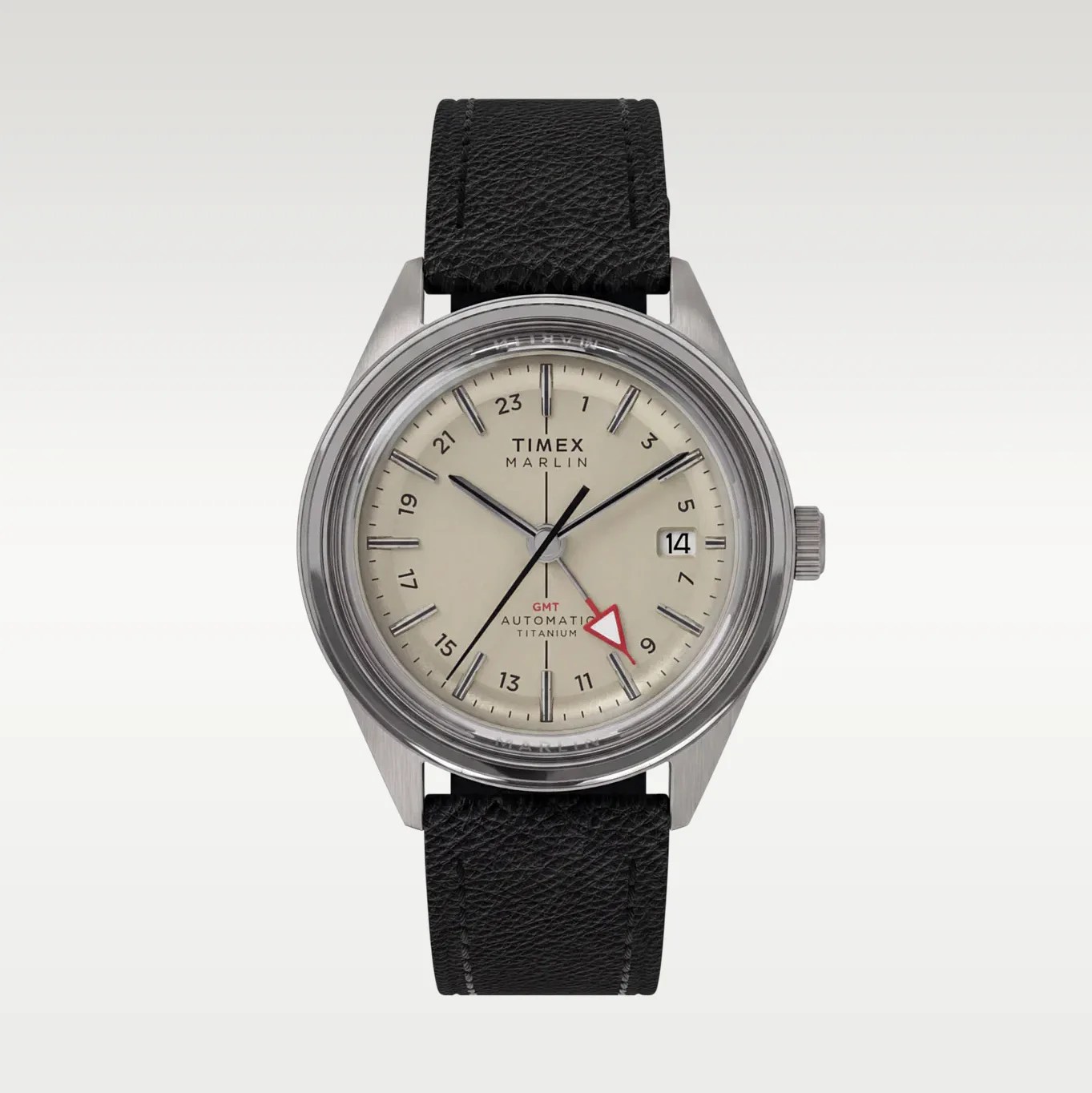 Timex Marlin automatic titanium watch with beige dial, black leather strap, and red GMT hand.