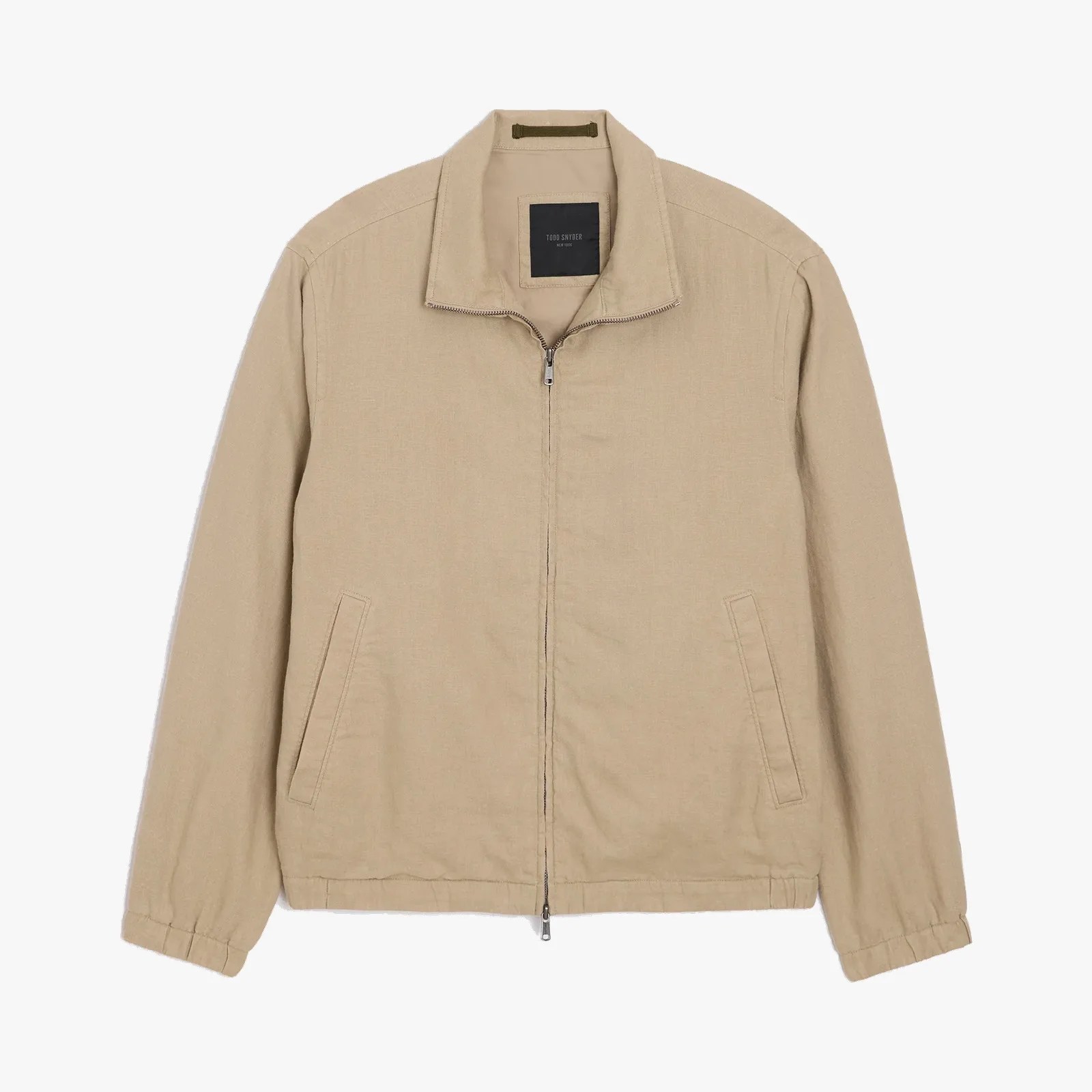 Beige zip-up jacket with elastic cuffs and side pockets laid flat.