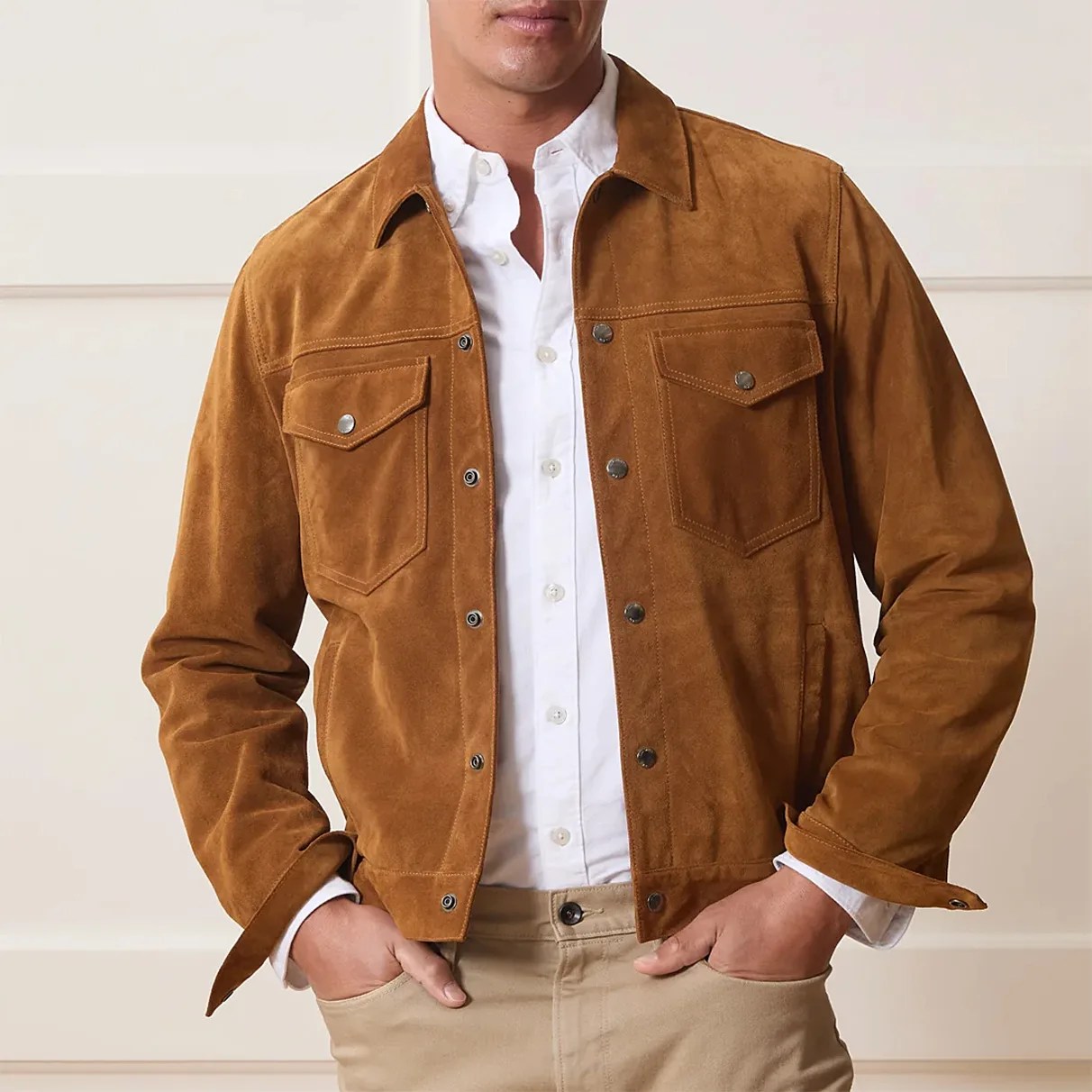 Brown suede jacket with snap buttons and flap chest pockets worn over a white button-up shirt.
