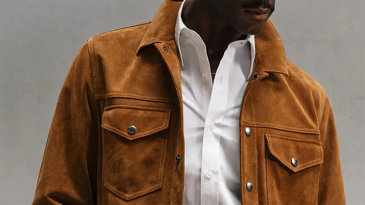 Brown suede jacket with snap-button flap pockets worn over a white button-up shirt.