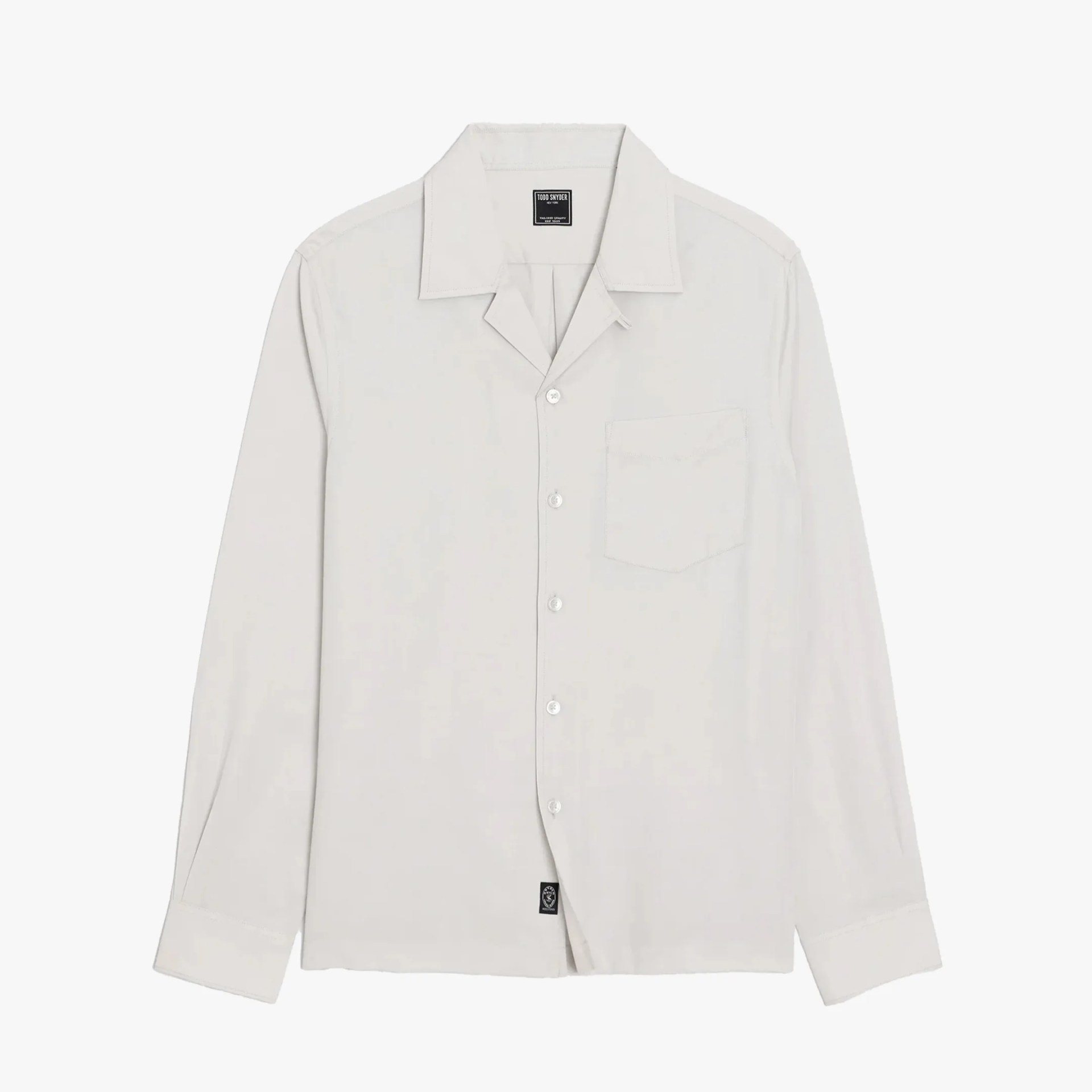 Off-white long-sleeve button-up shirt with a chest pocket and a black label inside the collar.