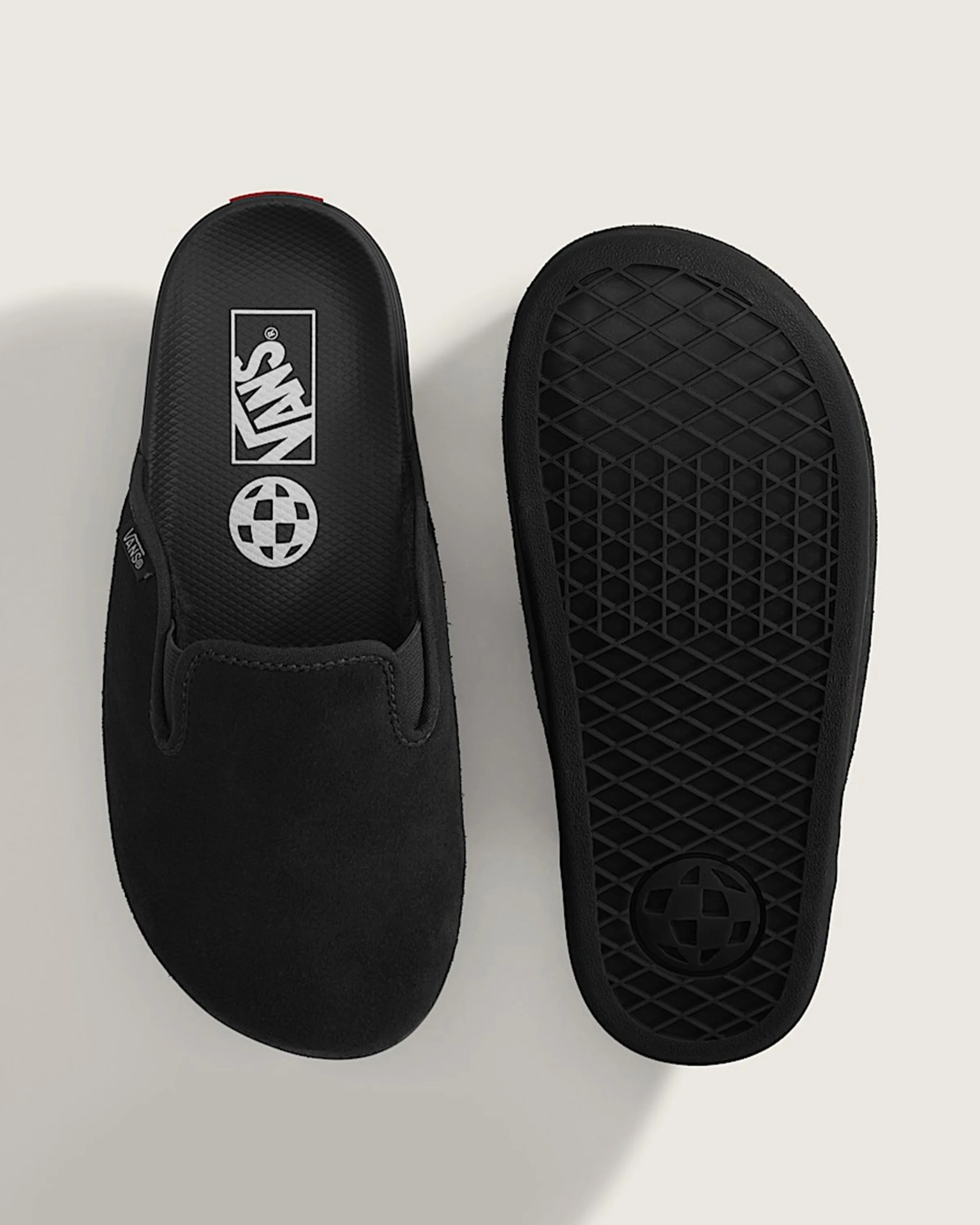 Pair of black Vans slip-on shoes showing top view of one shoe and sole of the other.