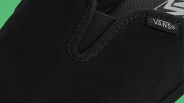 Close-up of black Vans slip-on shoe with suede texture and elastic side panel.