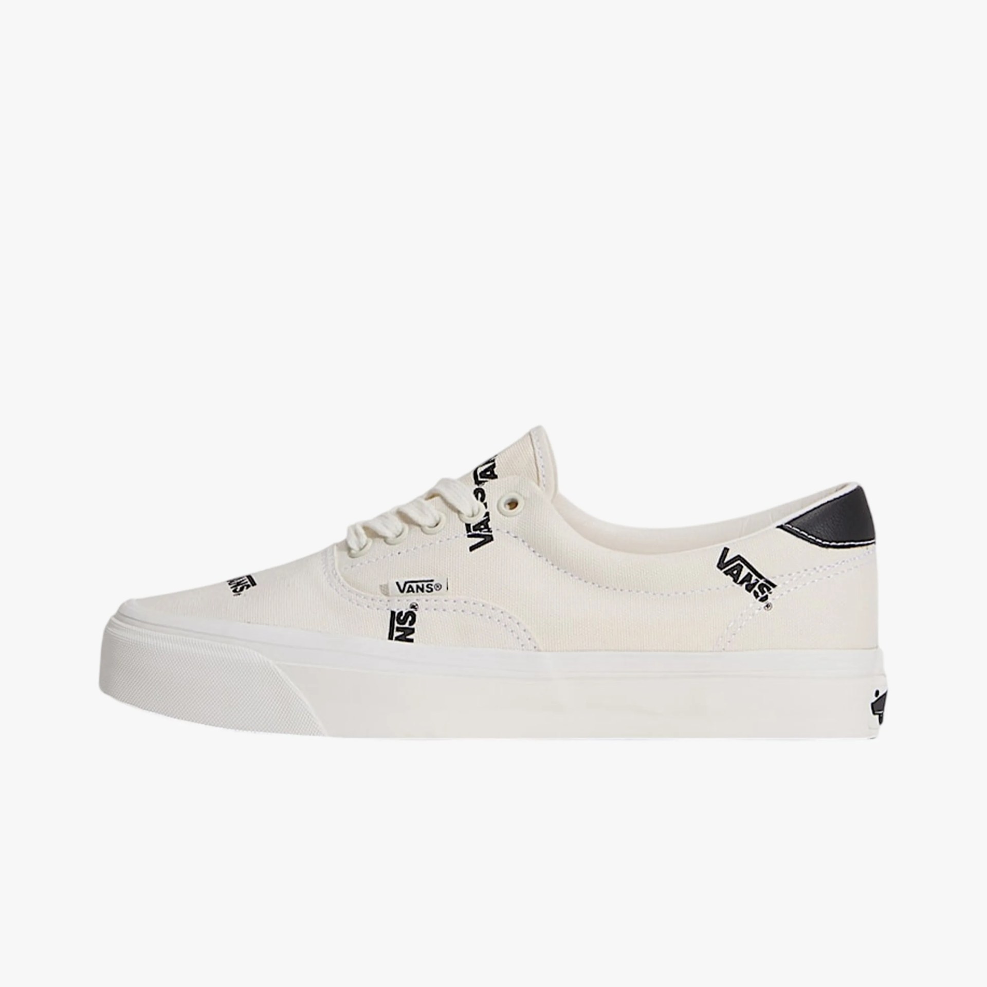 Off-white Vans low-top sneaker with black Vans logos and black heel tab.